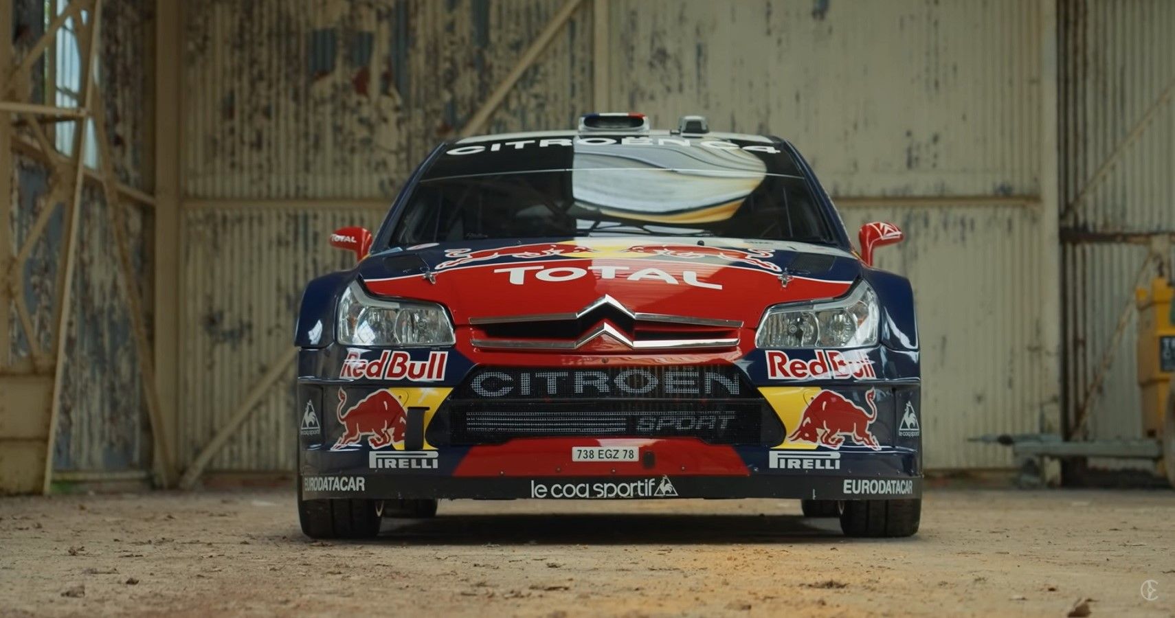 Citroen C4 WRC, red and blue with livery, front profile view in hangar