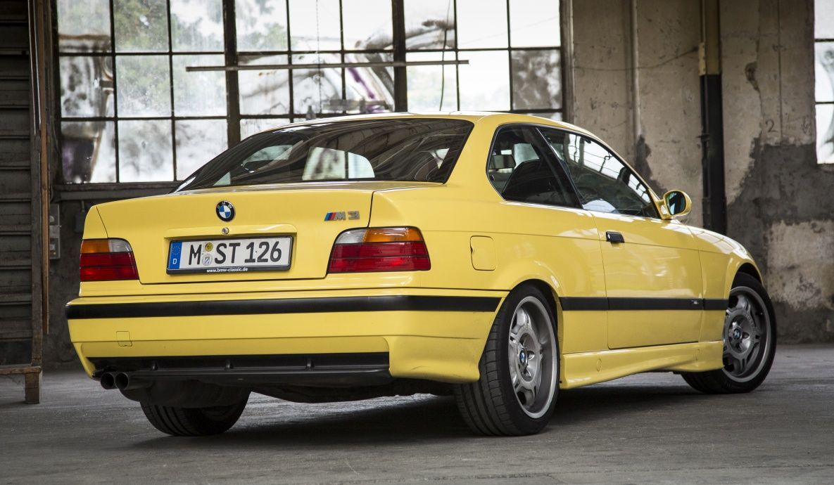 E36 BMW M3, yellow, rear quarter view