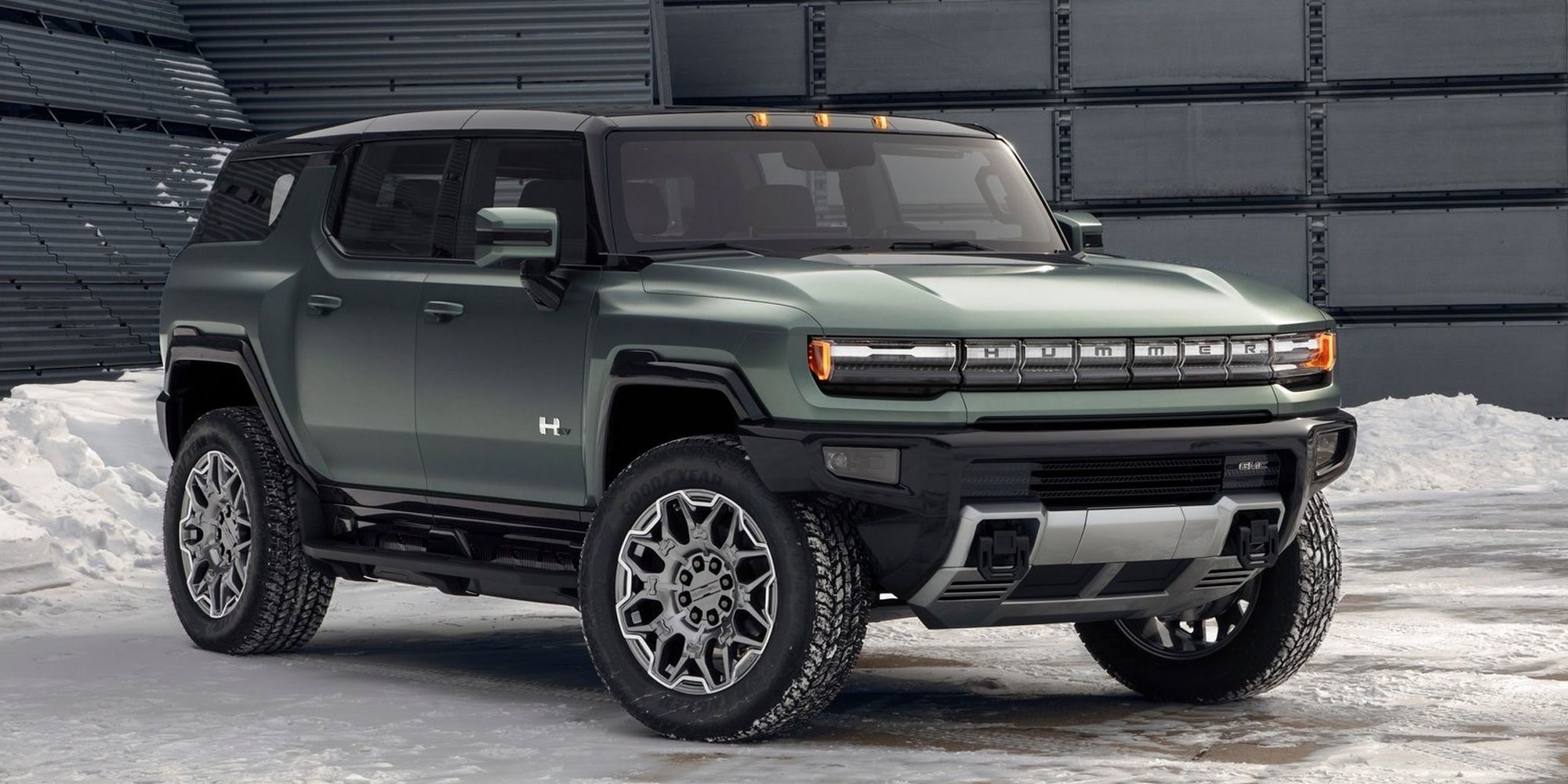 Front 3/4 view of a green Hummer EV SUV on an icy road