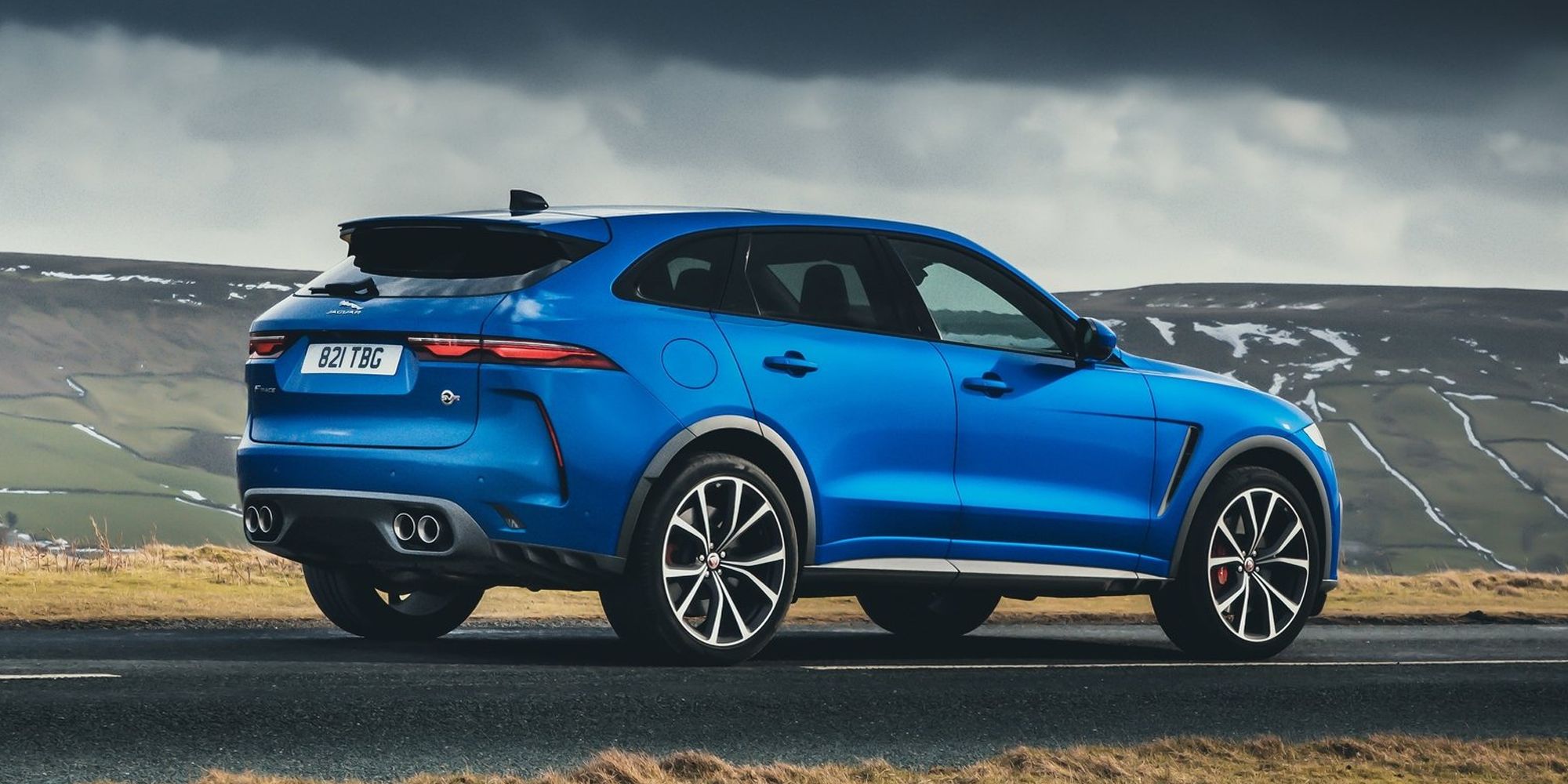 Rear 3/4 view of a blue F-Pace SVR on the move