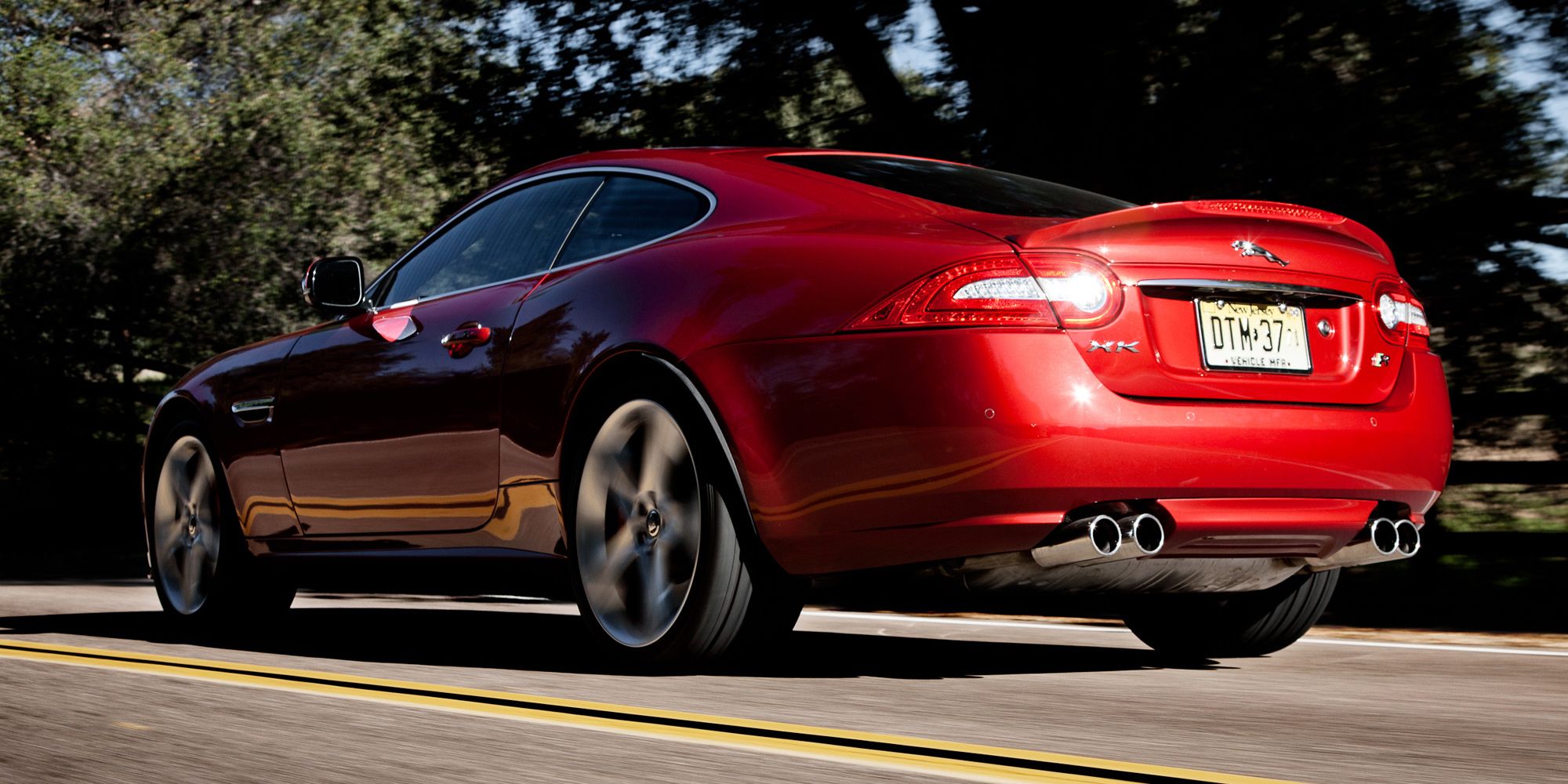 Rear 3/4 view of a red XKR on the move