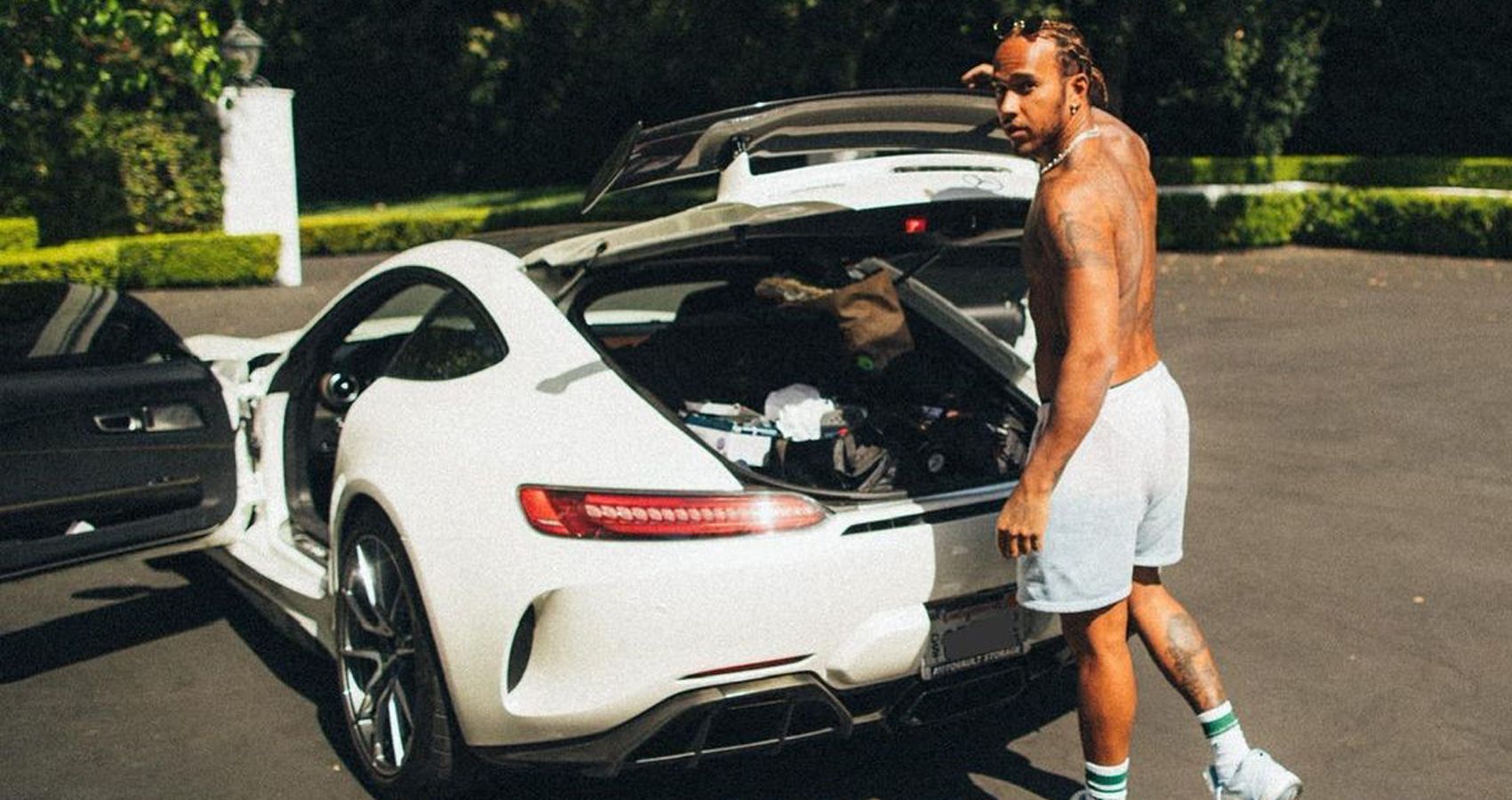Lewis Hamilton With His shirt off and his White Mercedes-Benz AMG-GT Supercar 
