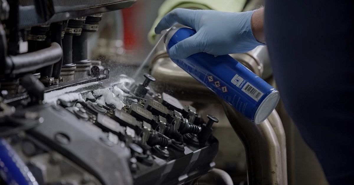 McLaren F1 engine cleaning, close up of spray can cleaning engine