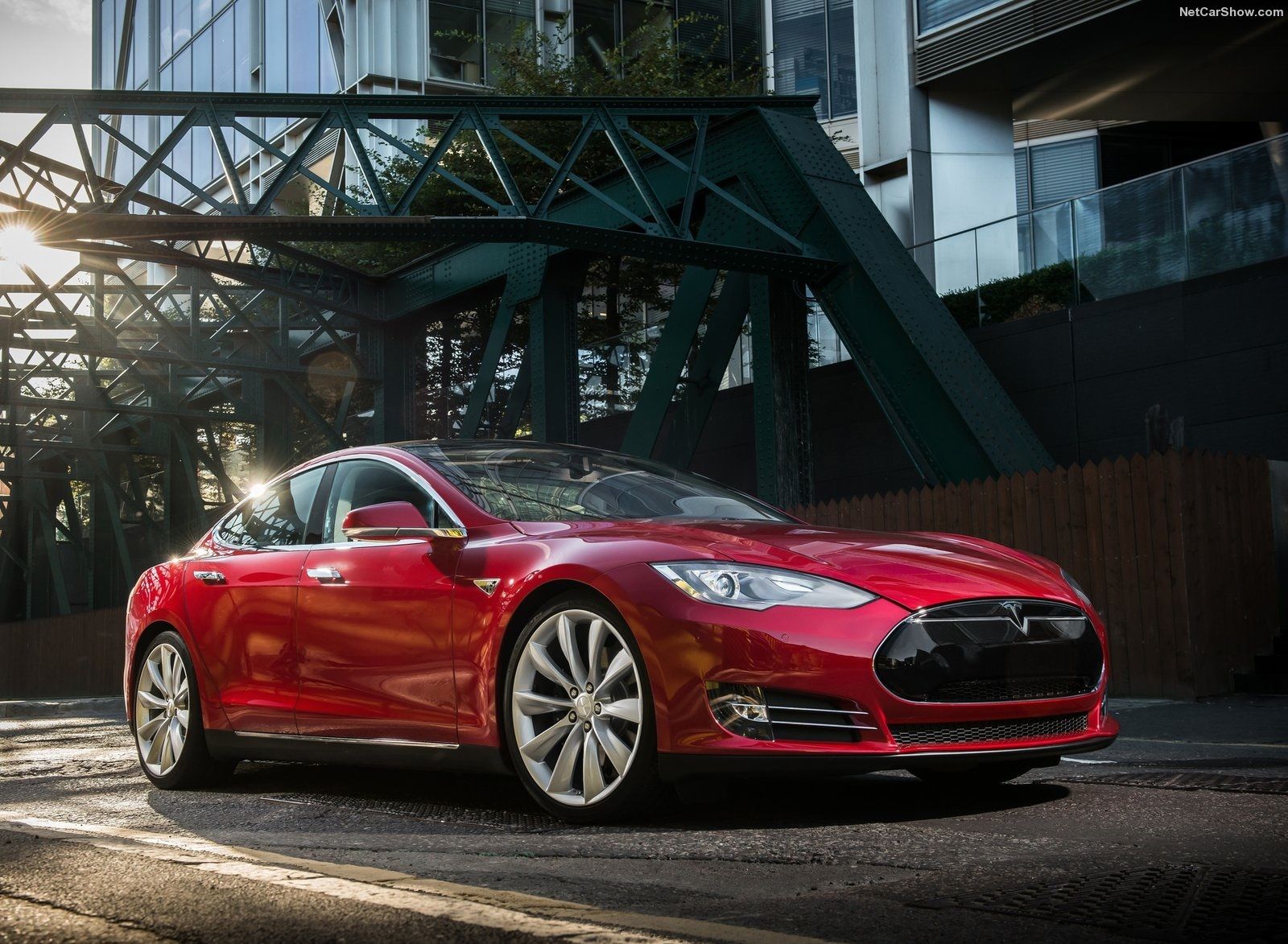 Red Tesla Model S under bridge