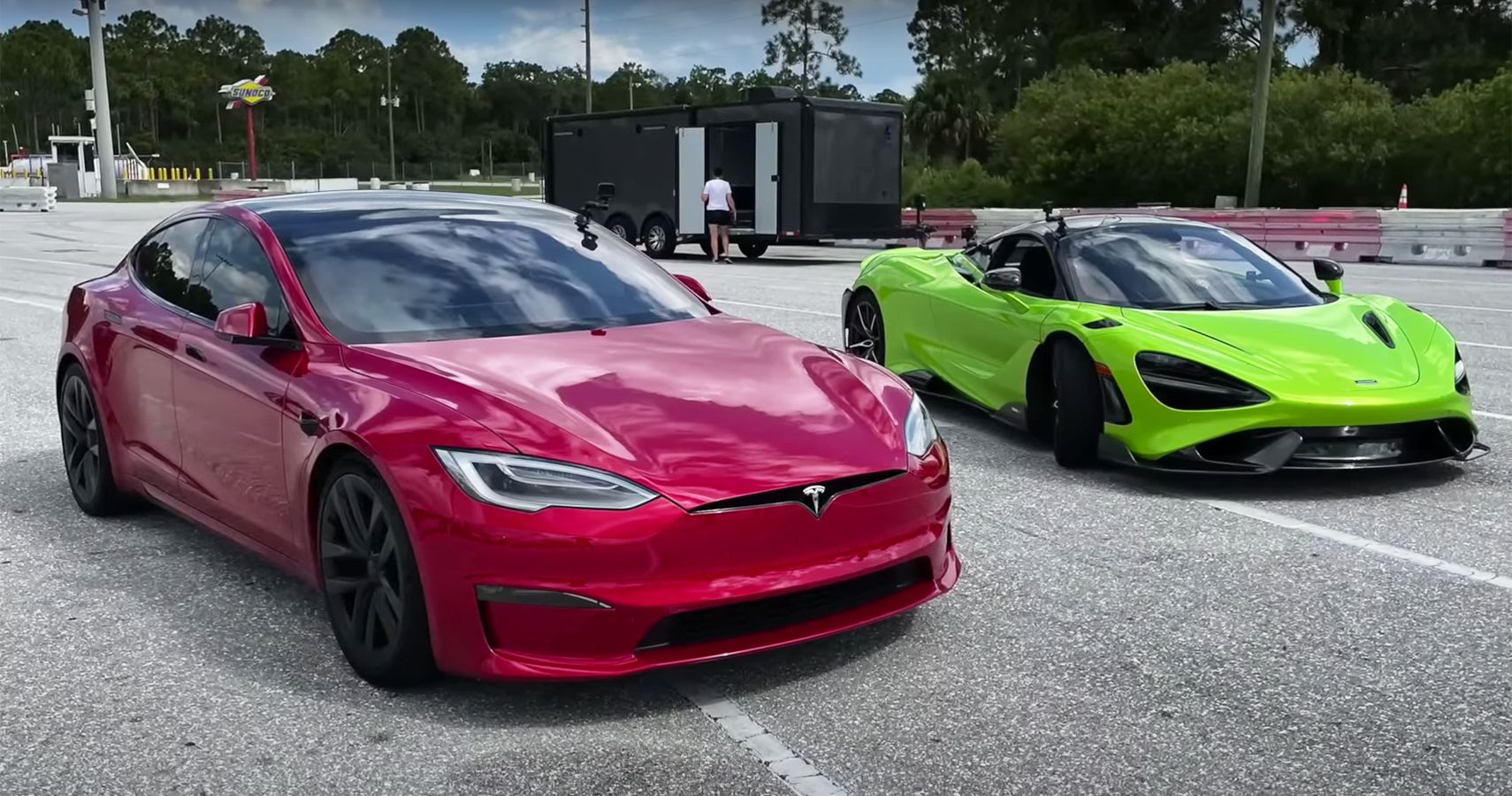 red 2021 Tesla Model S Plaid and green 2021 McLaren 765LT