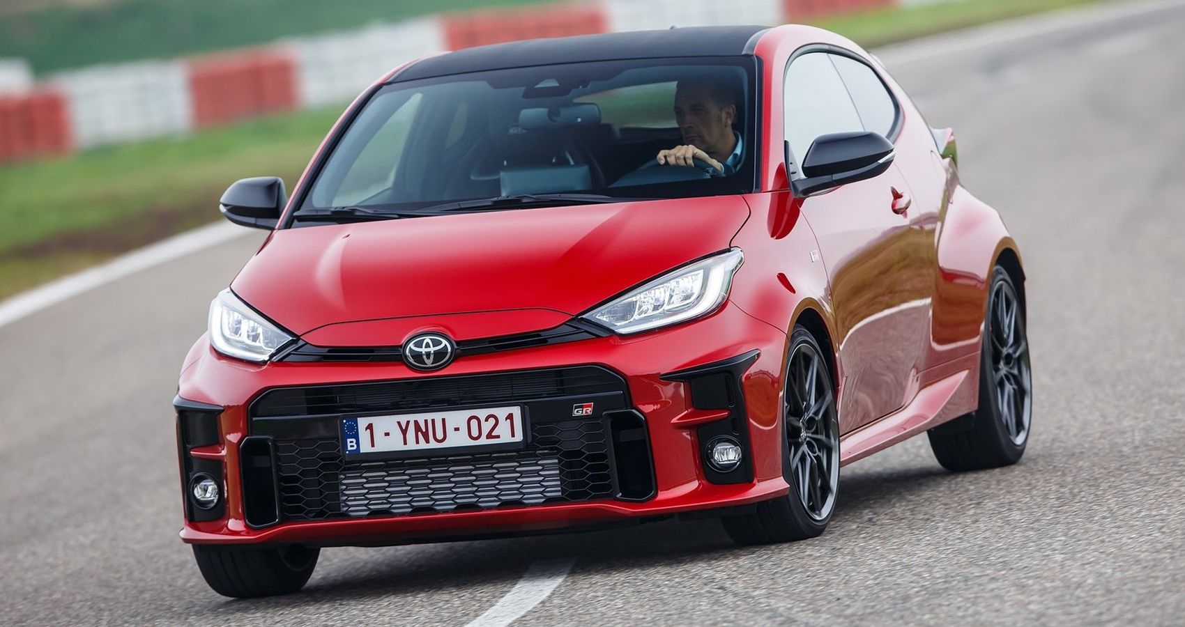 The front of a red GR Yaris cornering on the race track