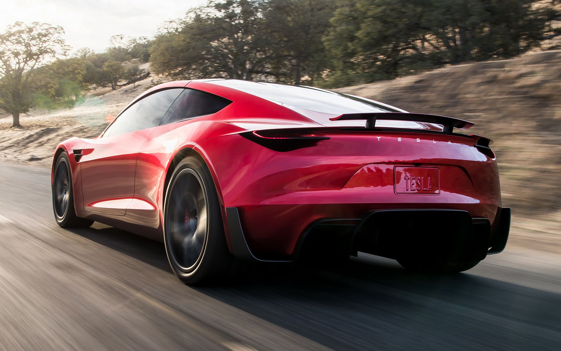 The 2023 Tesla Roadster speeds up on the road. 