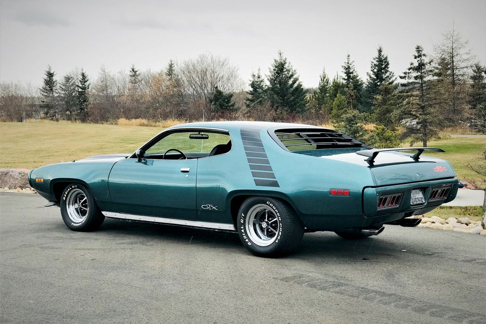 Green 1971 Plymouth GTX on the road