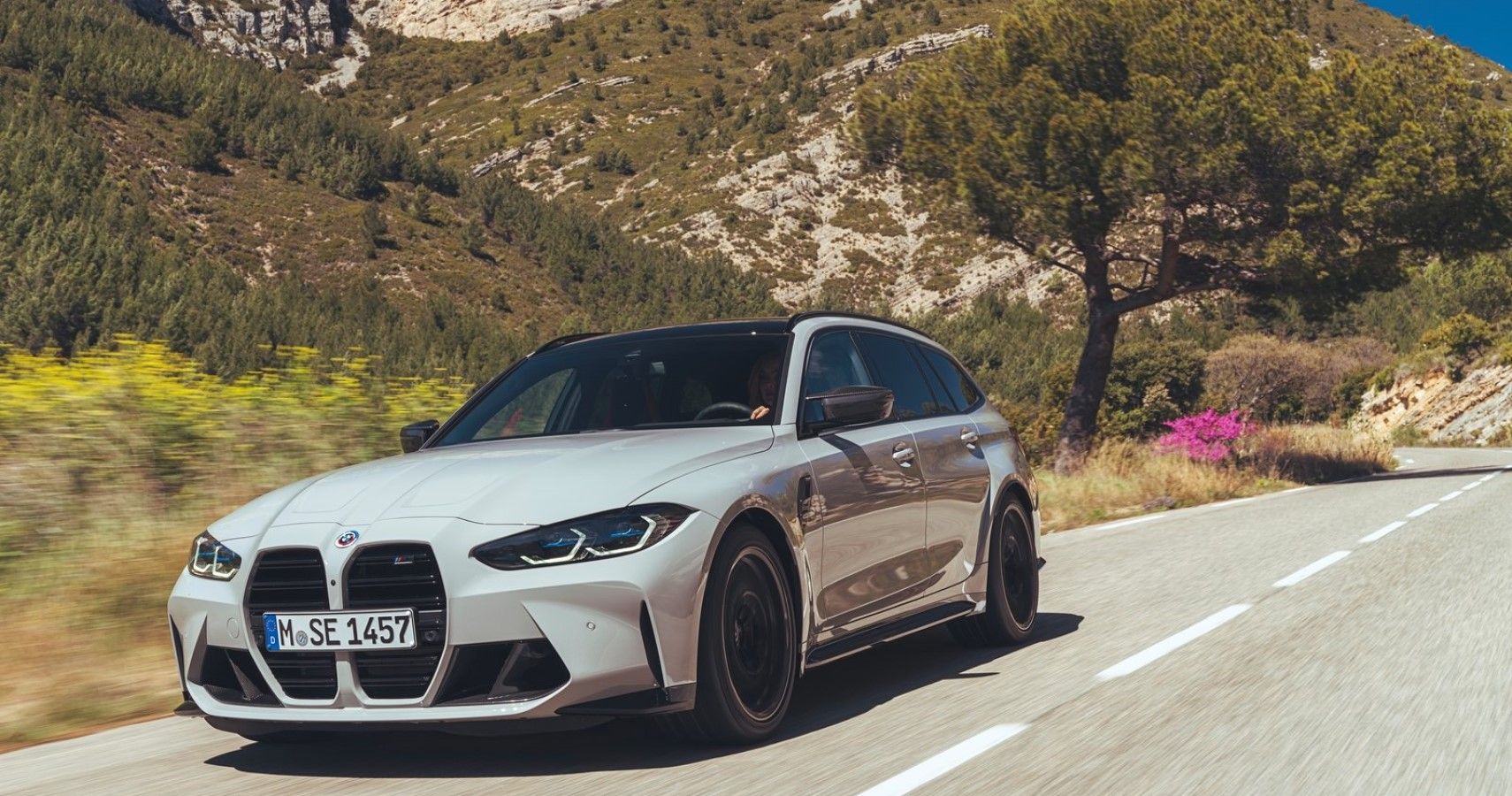2023 BMW M3 Touring accelerating front third quarter view