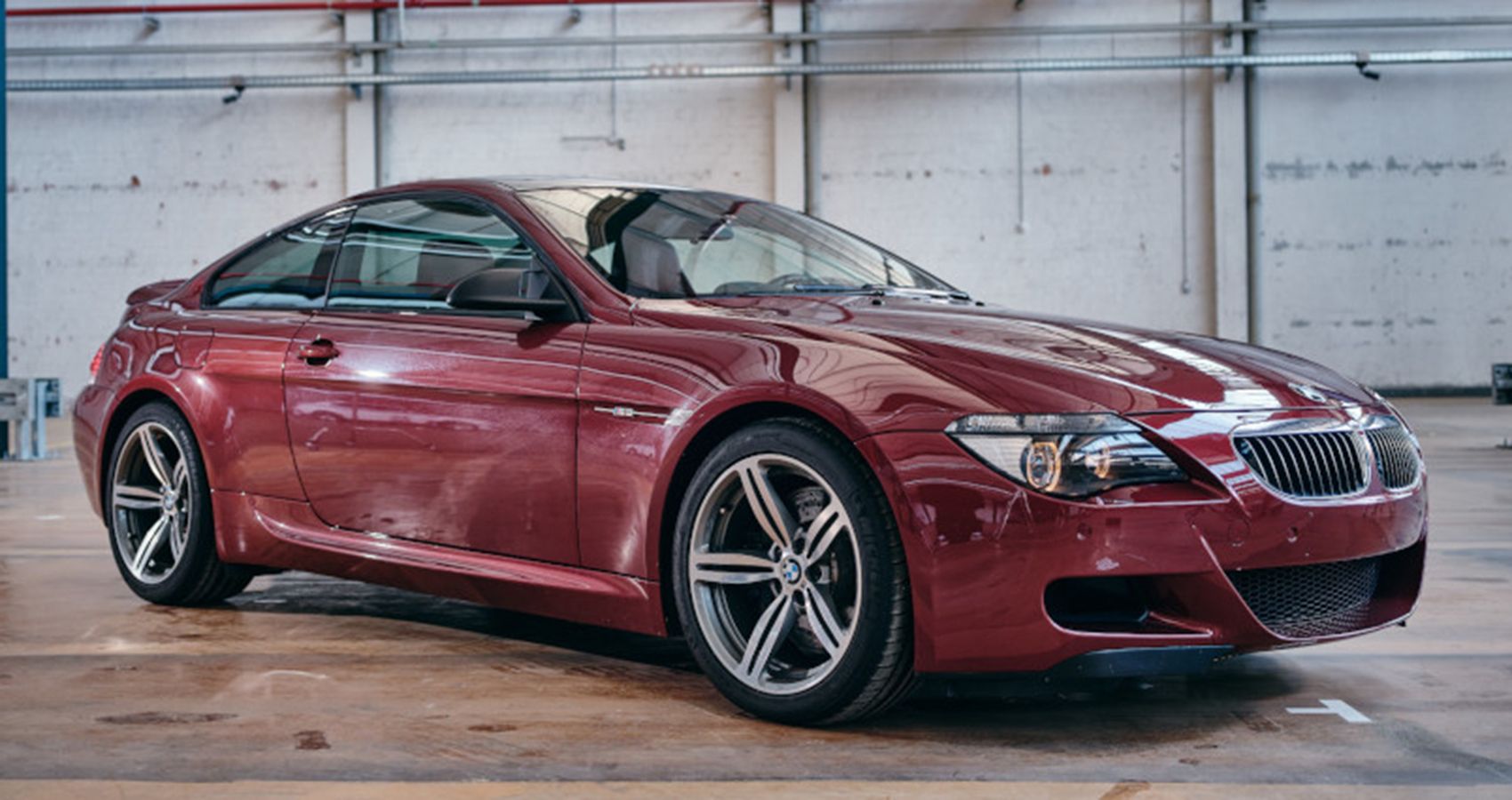 BMW M6 CSL secret garage prototype, dark red, front quarter view, in hangar