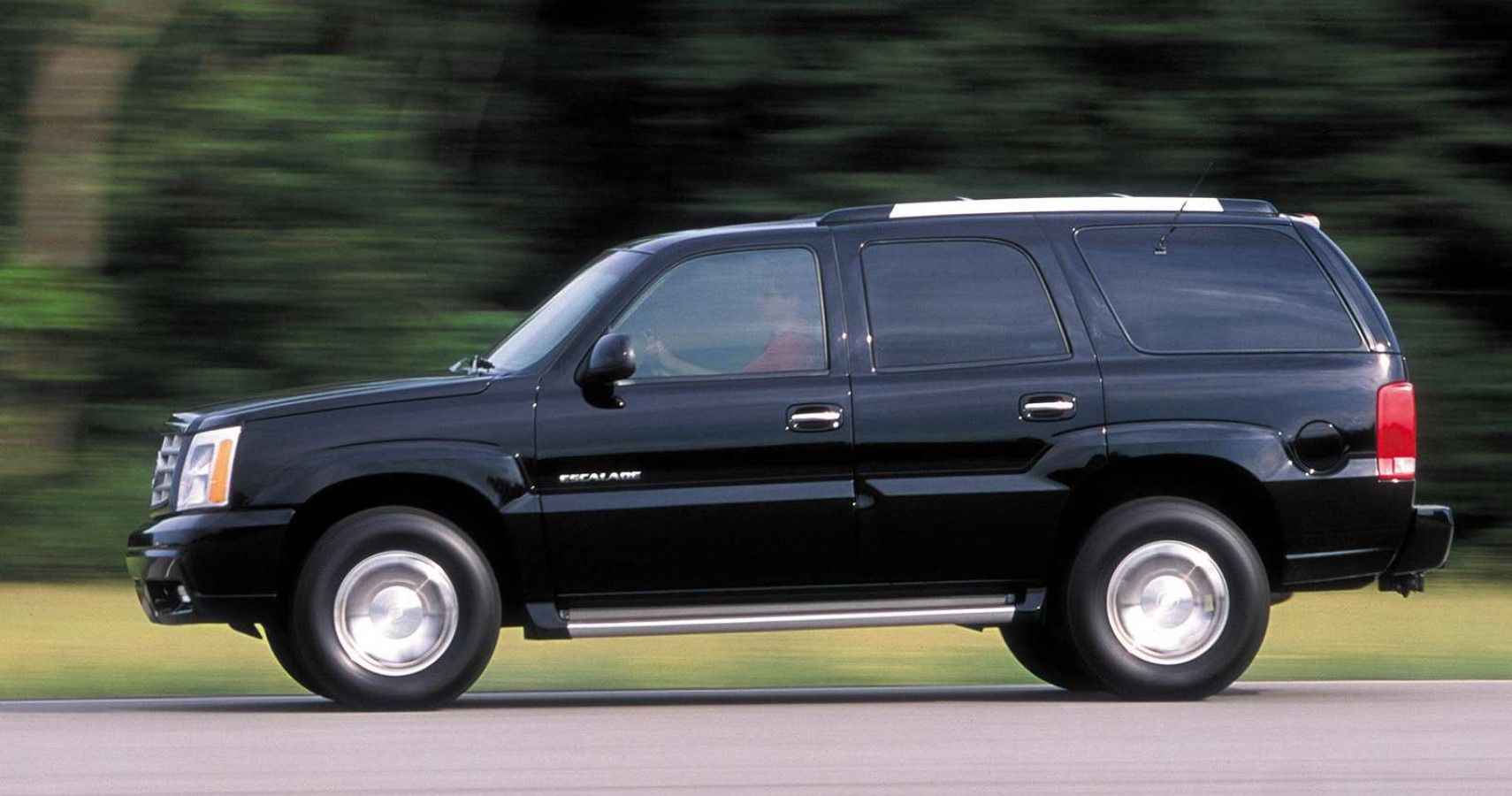 Second generation Cadillac Escalade accelerating side view