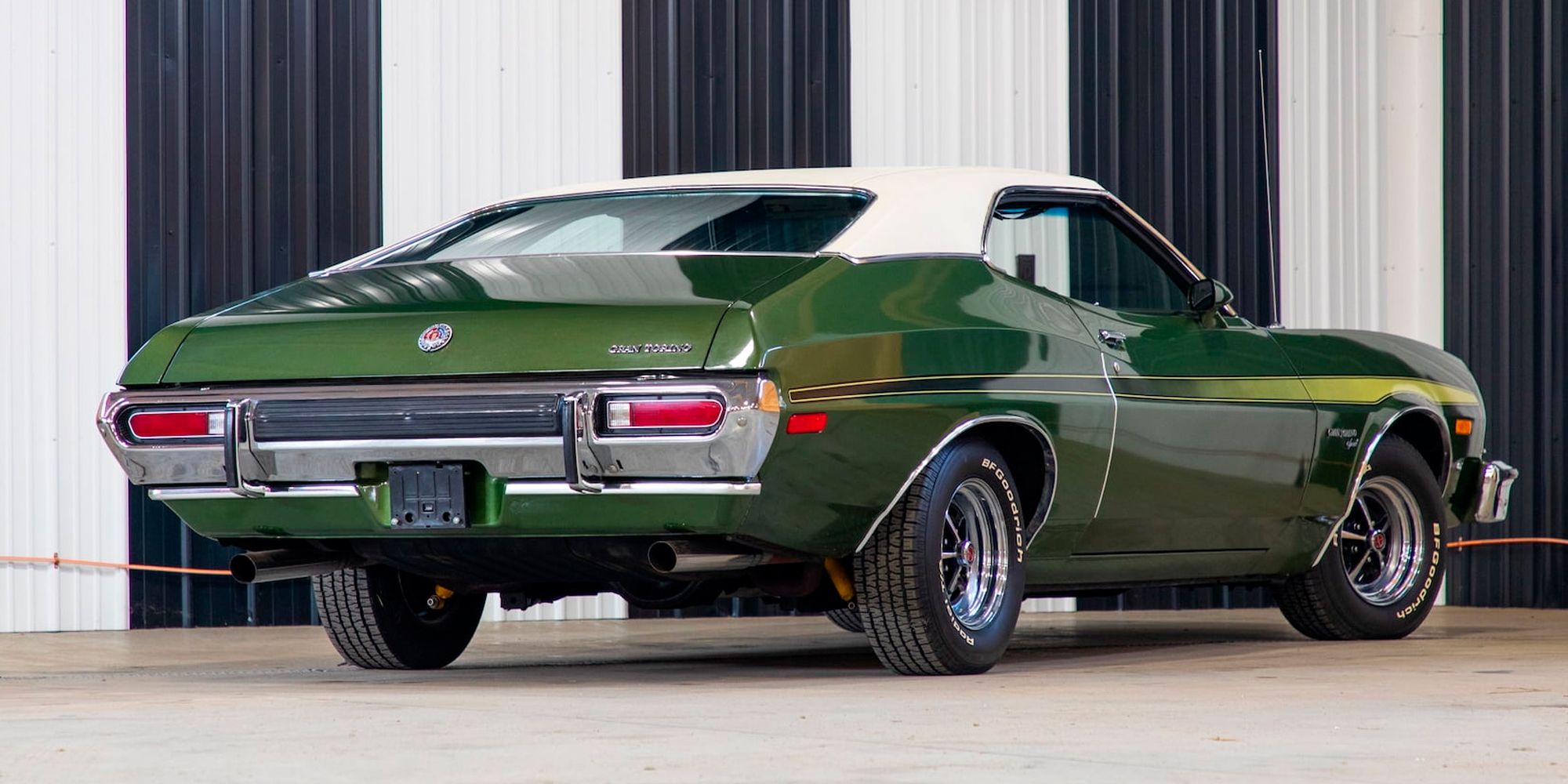 Rear 3/4 view of a green 1973 Gran Torino, parked