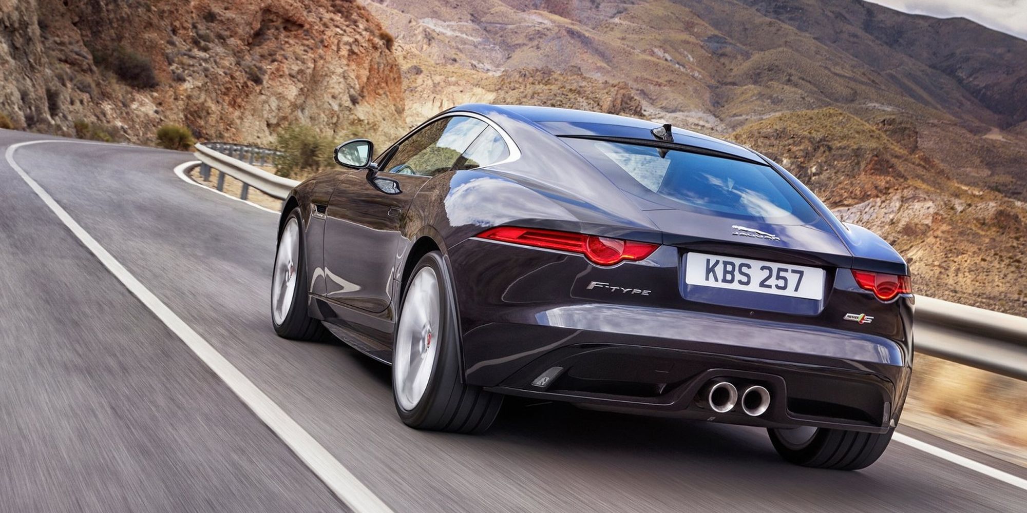 The rear of a black F-Type Coupe on the move