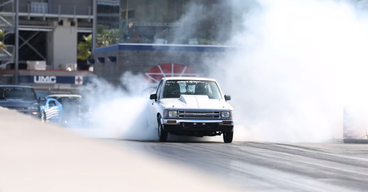 Larry Chen YouTube Channel 1989 White Toyota Hilux LS swap Front view burnout at drag