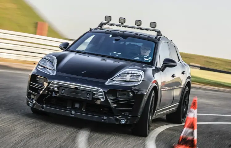 Black Porsche Macan EV on track