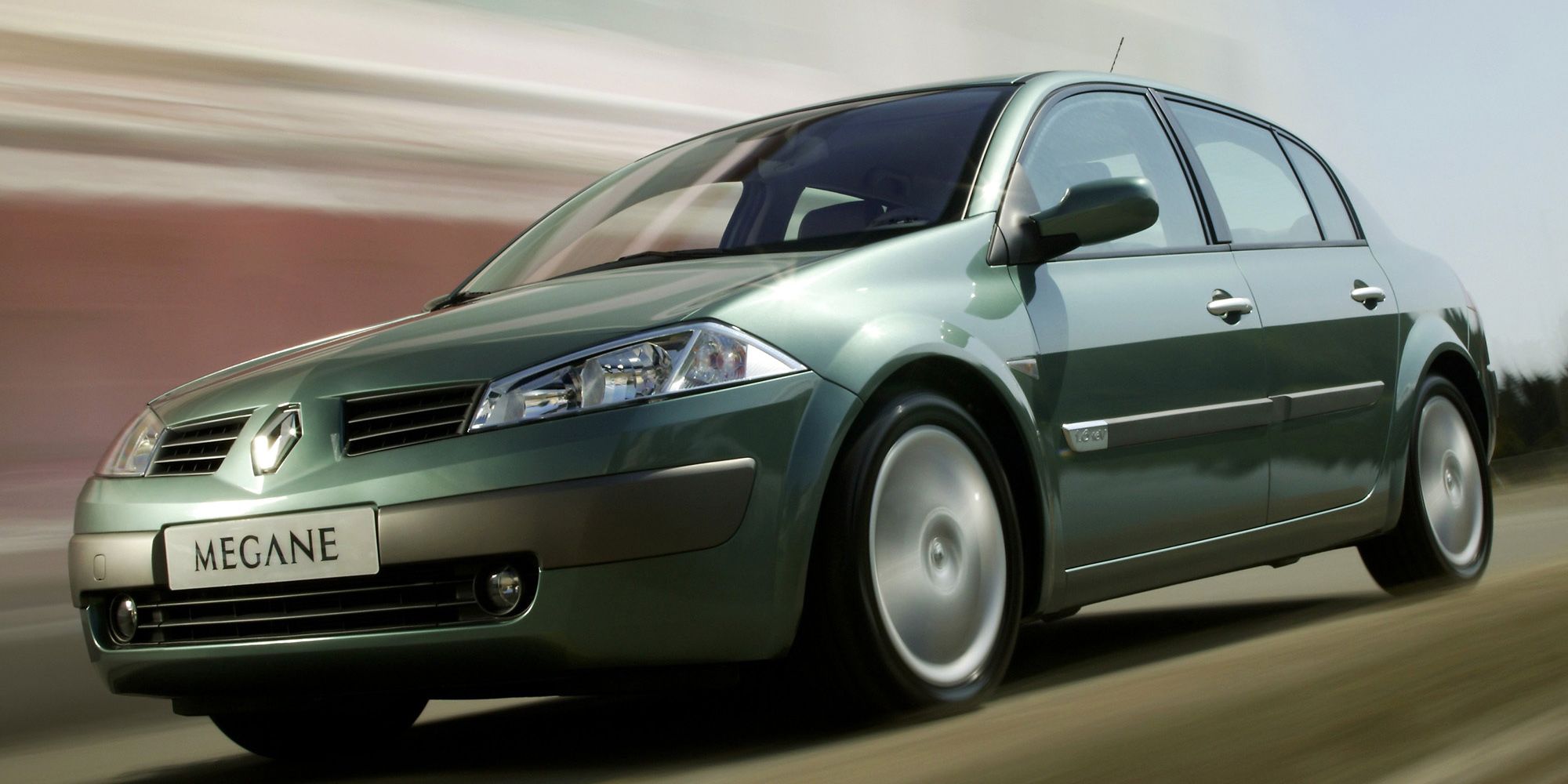 Front 3/4 view of a dark green Megane II sedan on the move