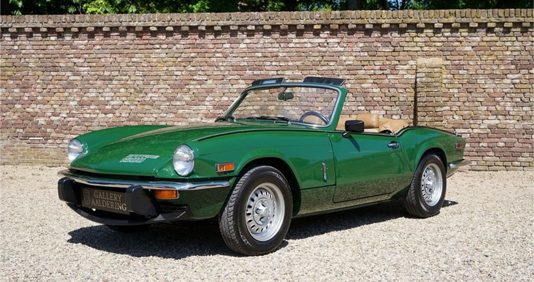 British Racing Green Triumph Spifire 1500 sports car parked