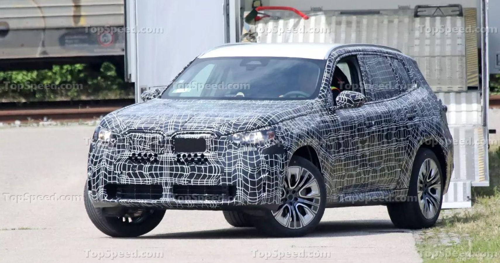 BMW X3 Spy shot camo front and side view
