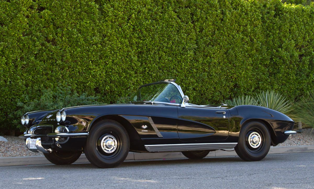 1962 Chevrolet Corvette parked by a hedge