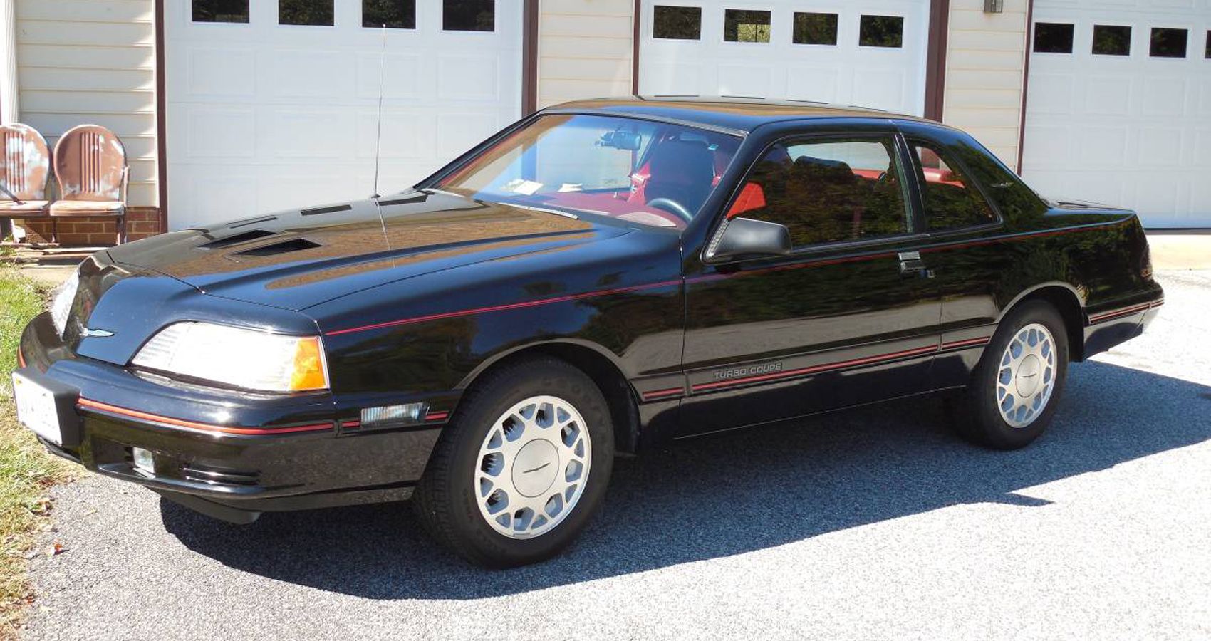 1988 Ford Thunderbird Turbo Coupe, black, front quarter view, infront of garage