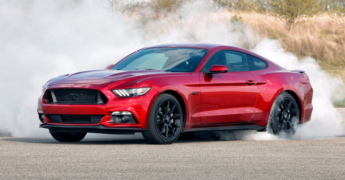Red 2016 Ford Mustang drifting 