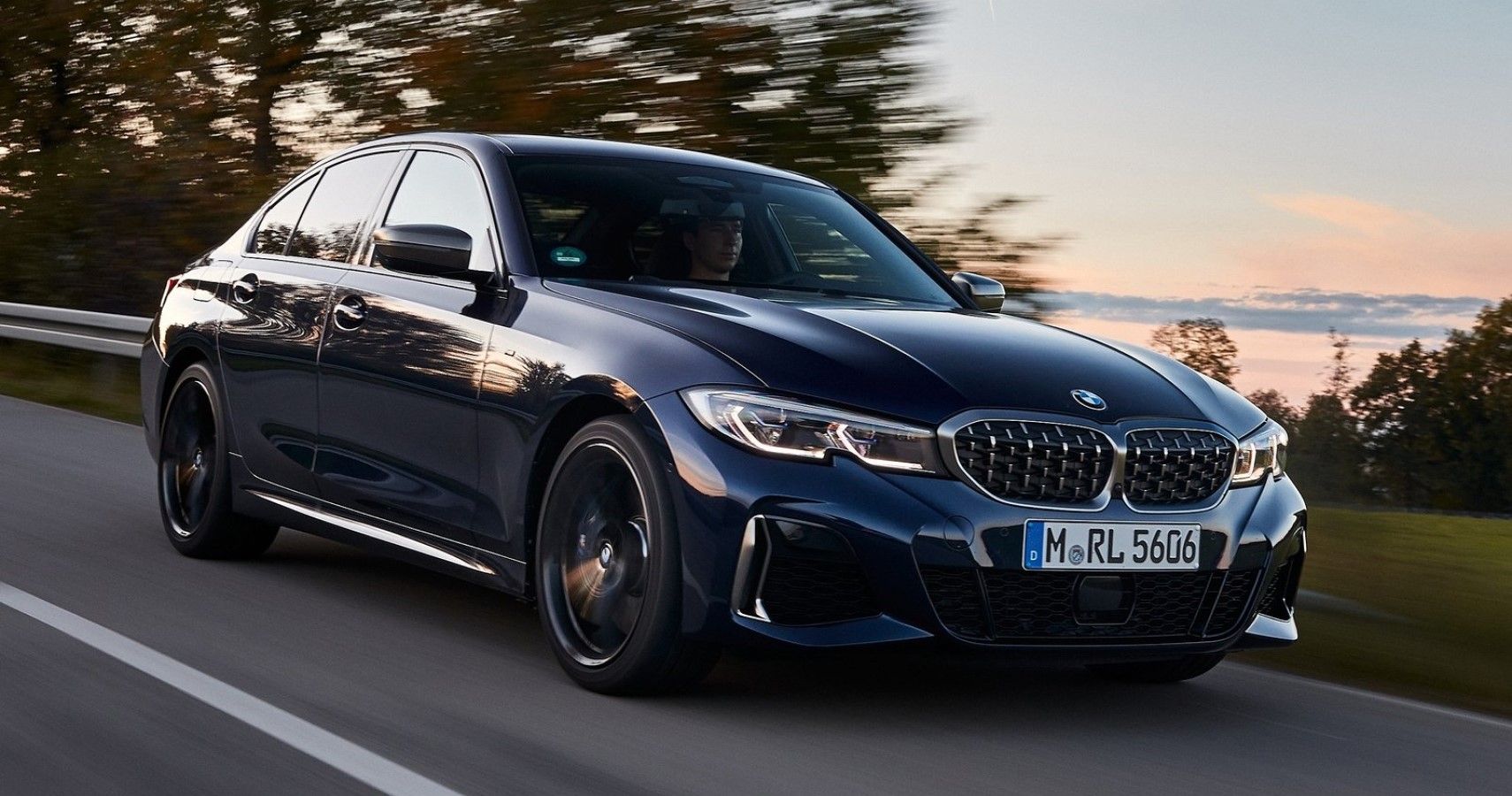 2020 Blue BMW M340i driven around the countryside front third quarter view