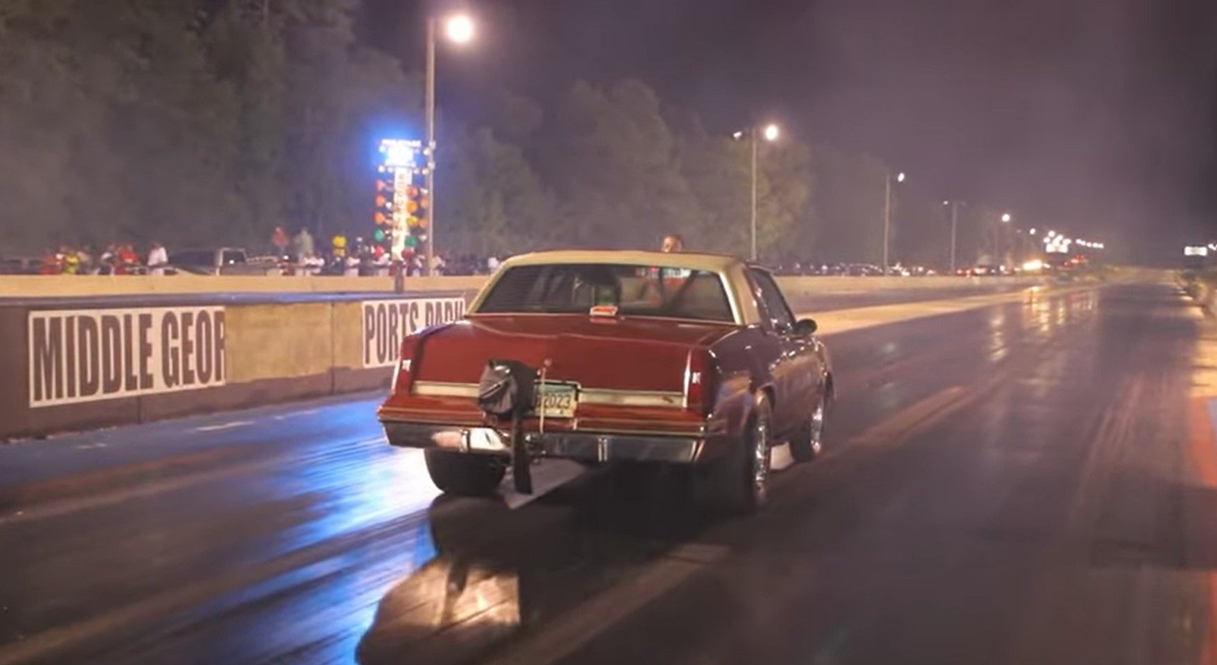 Oldsmobile Cutlass Drag Racer, red, rear quarter view on drag strip