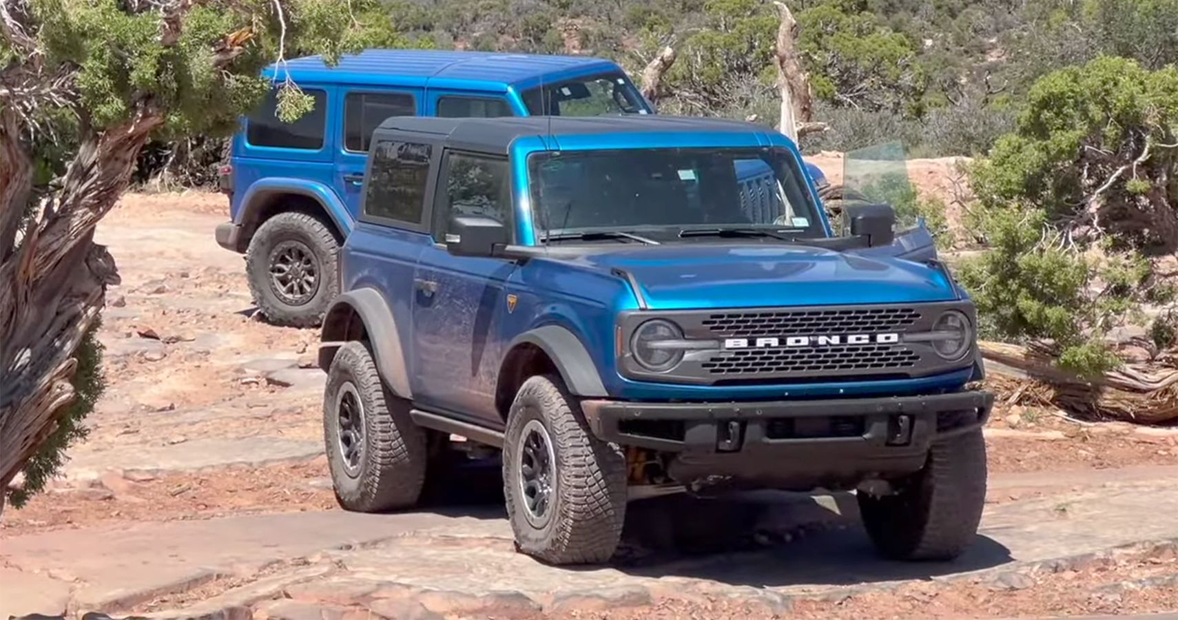 blue Ford Bronco and blue Jeep Wrangler Rubicon 392 in Moab