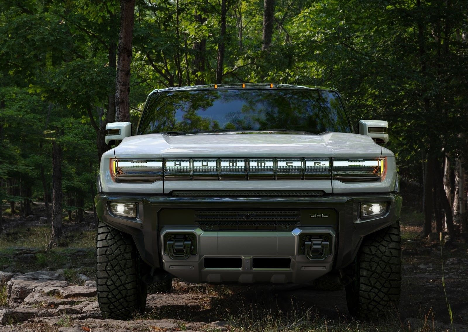 GMC Hummer EV, white, front profile view, in forest