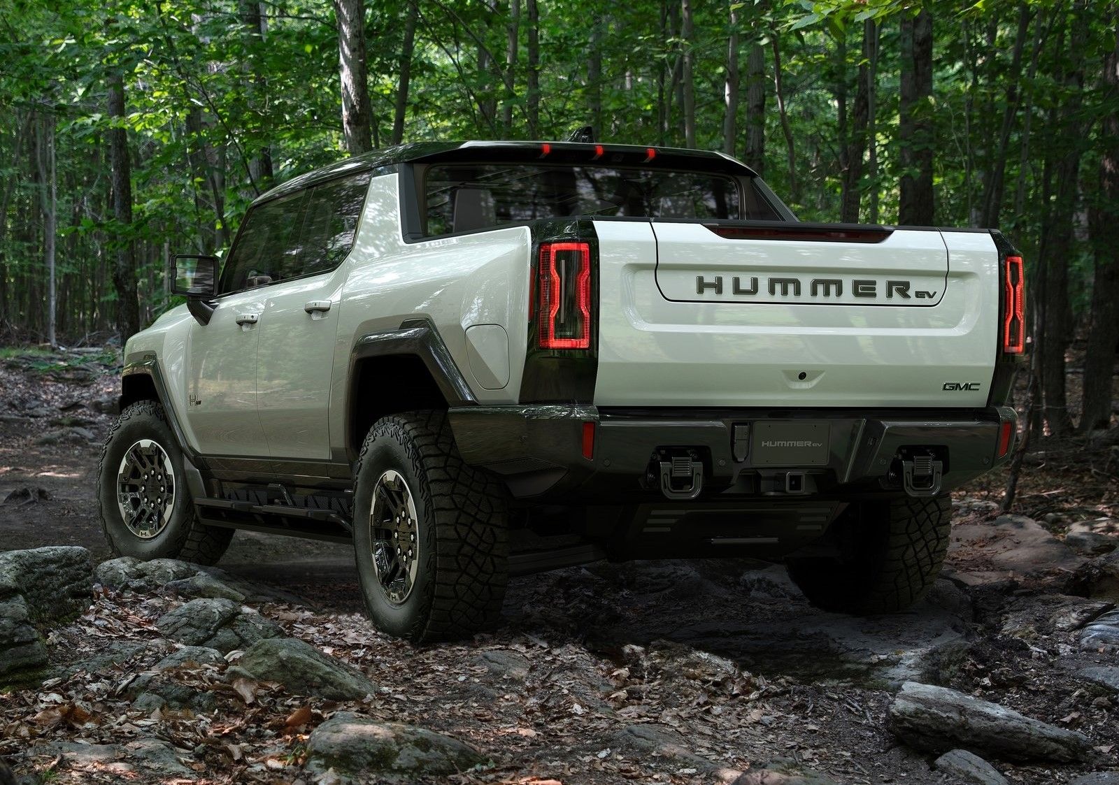 GMC Hummer EV, rear quarter view, in forest, white