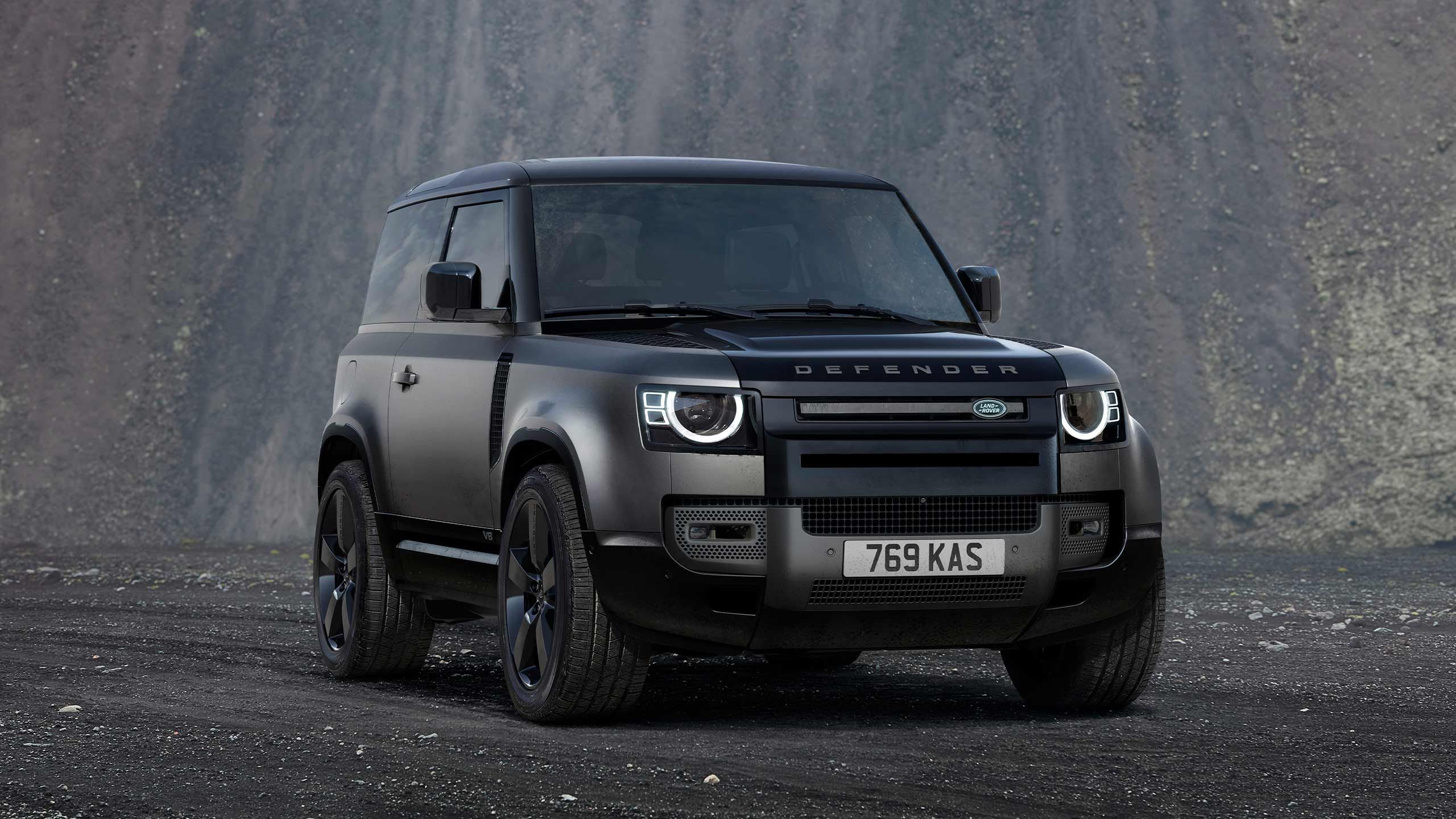 A front shot of a Black Land Rover Defender.