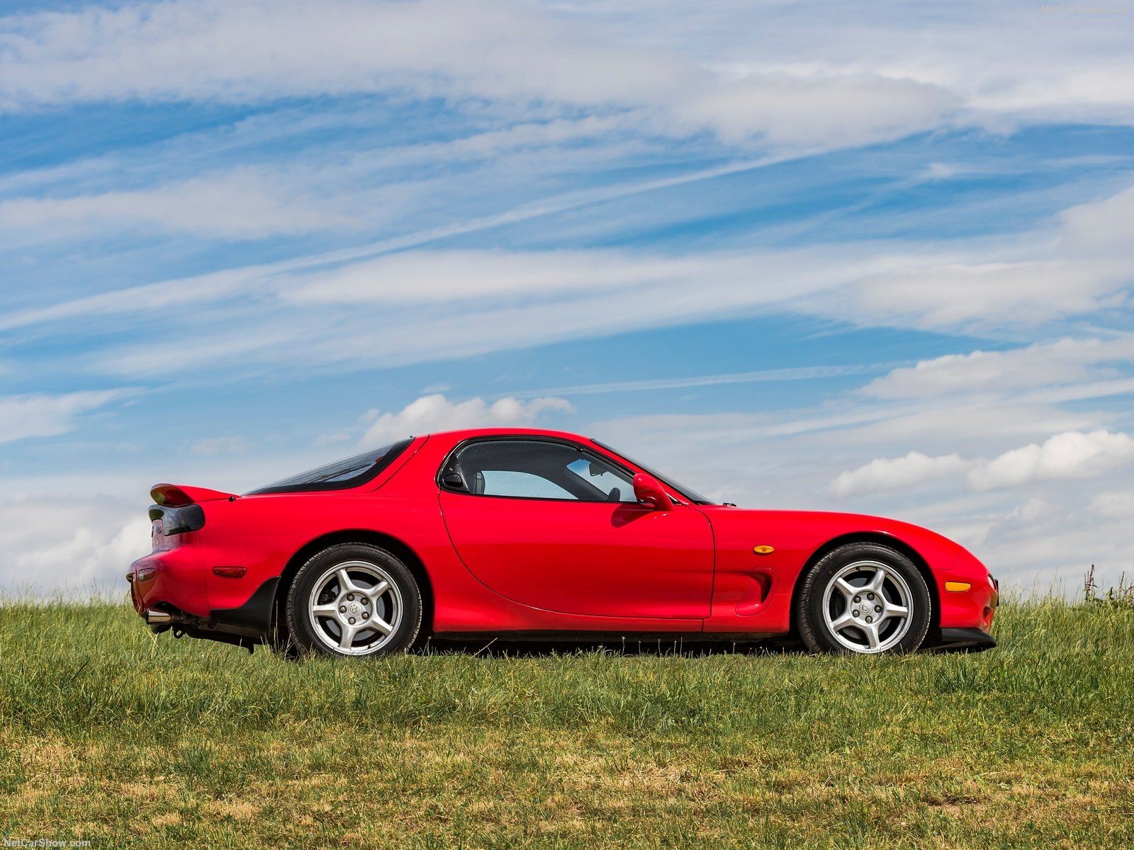 Mazda RX-7 FD, red, side profile view on grass