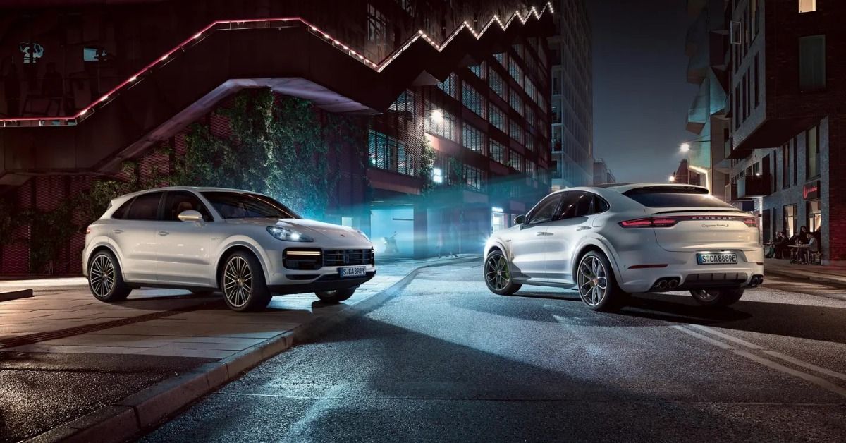 Two The Porsche Cayenne models parked on the street. 