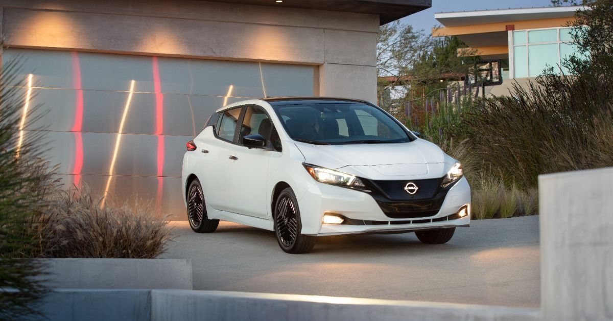 The 2023 Nissan Leaf parked in front of a private house. 