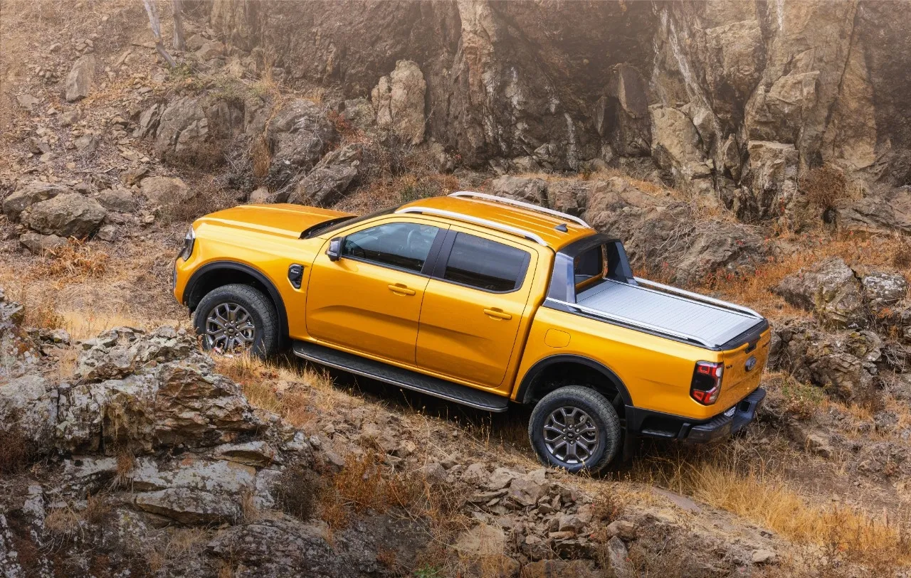 Orange-2023-Ford-Ranger-driving-on-a-mountain-road-highlighting-how-Ford-Ranger-EV-could-be-the-best-electric-truck