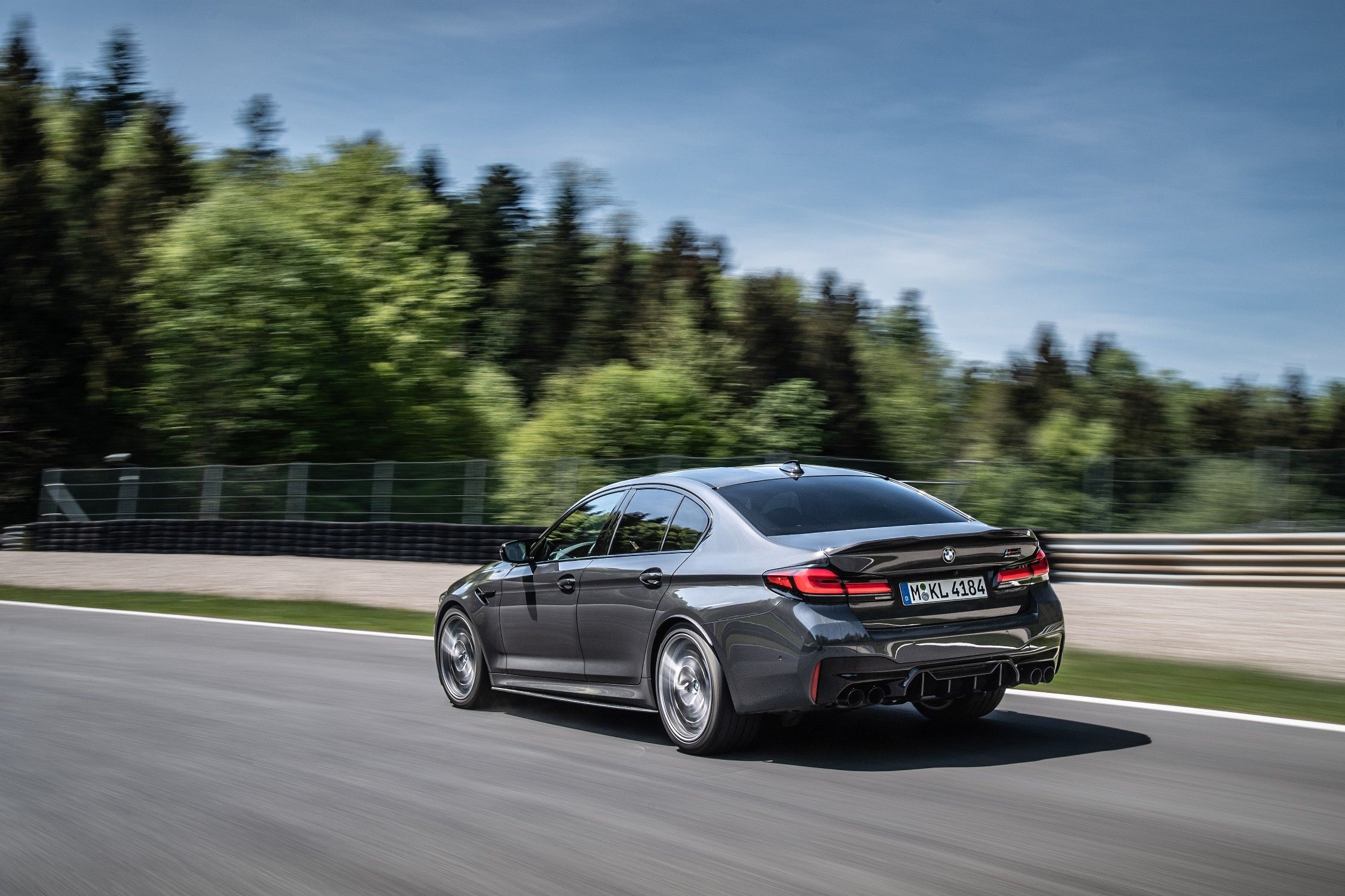 Gray 2023 BMW M5 Competition on track