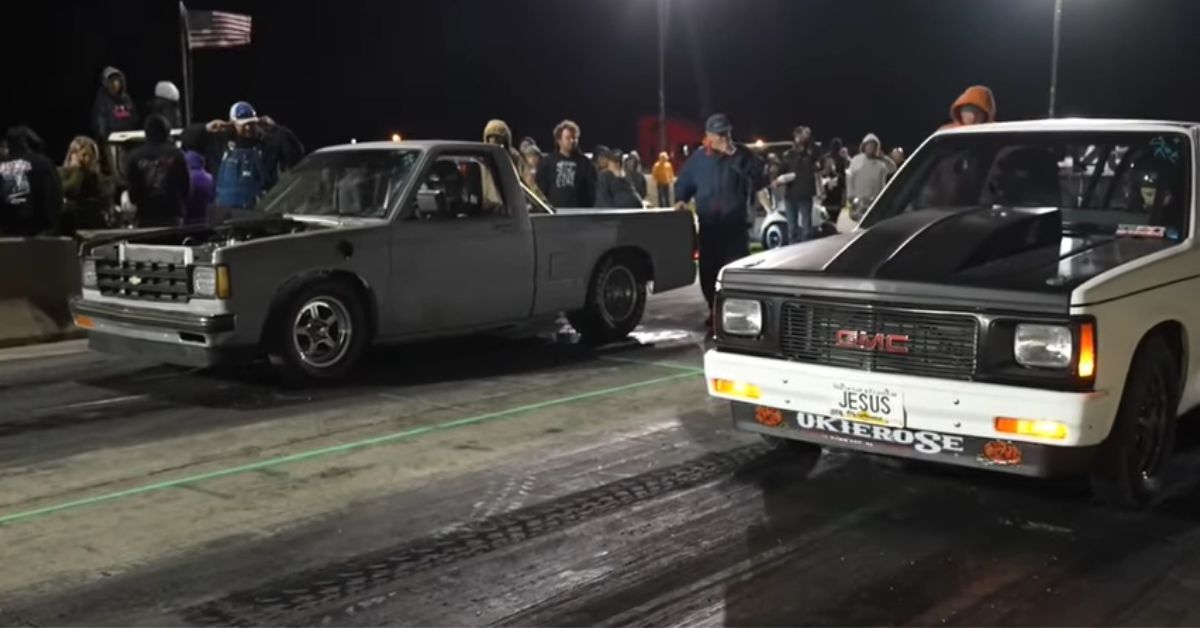 Chevy S-10 drag race against GMC S-15, front quarter view at starting line, night