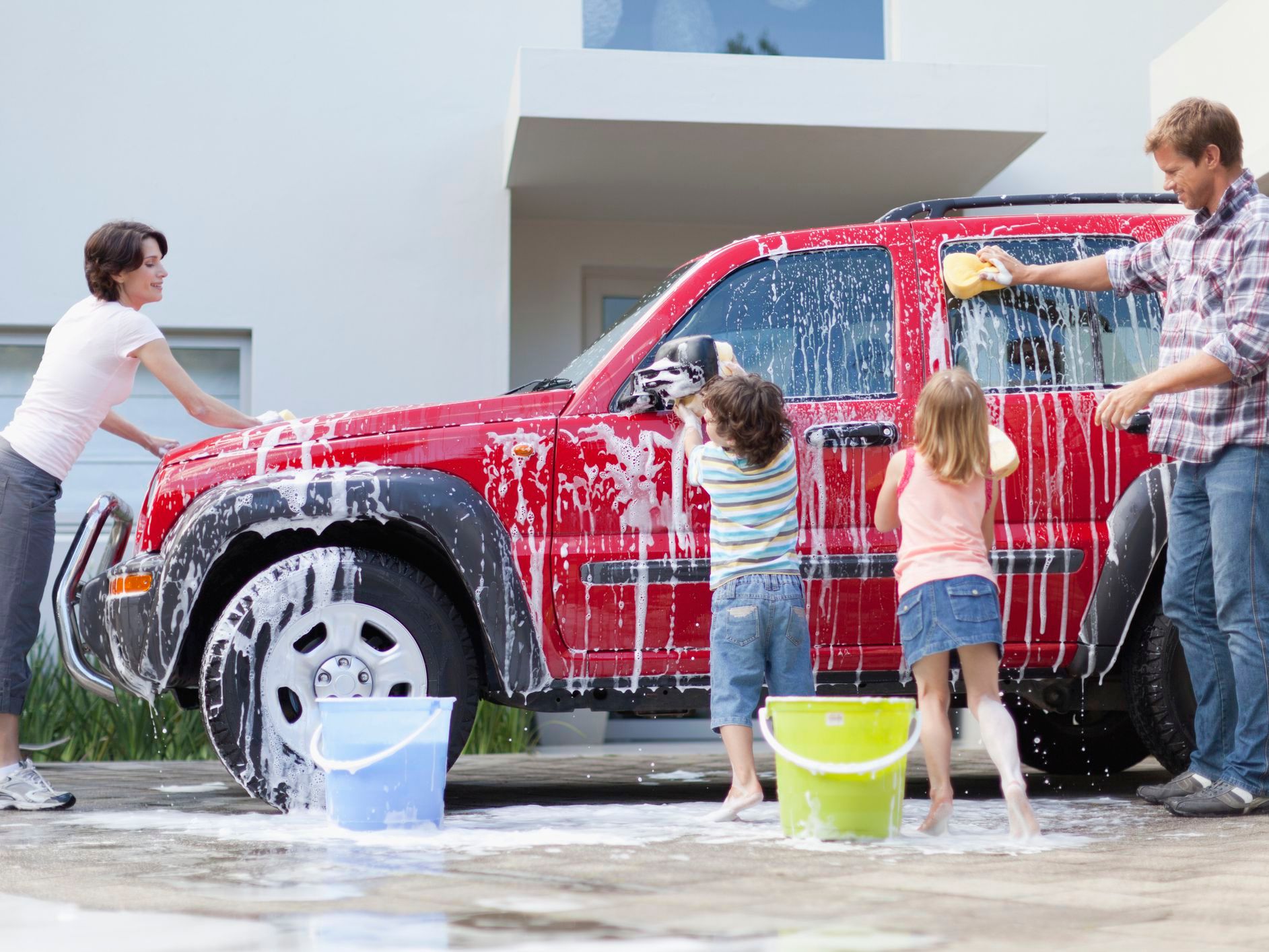 family-washing-car-together