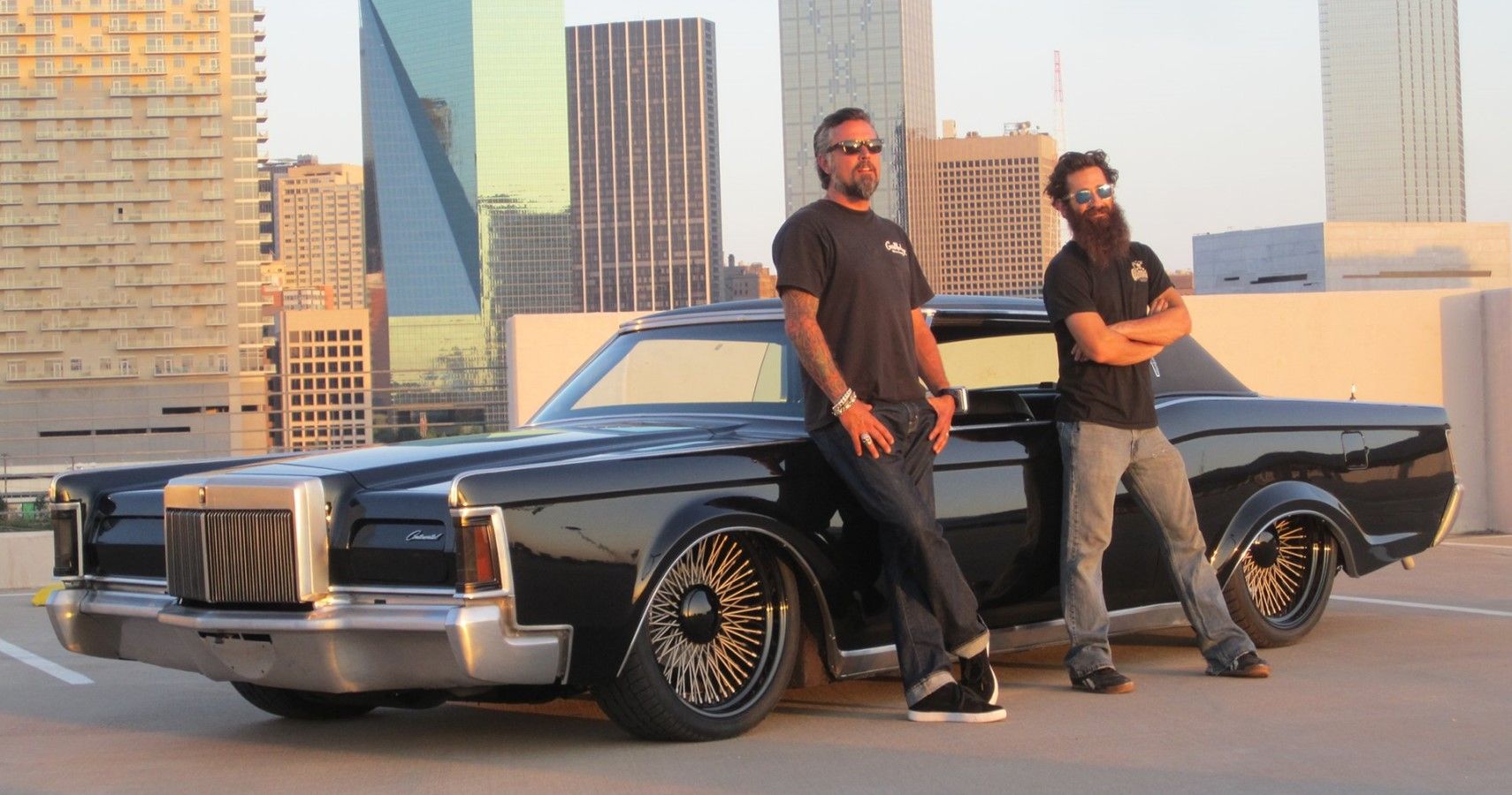 Richard Rawlings and Aaron Kaufman posing with a custom muscle car