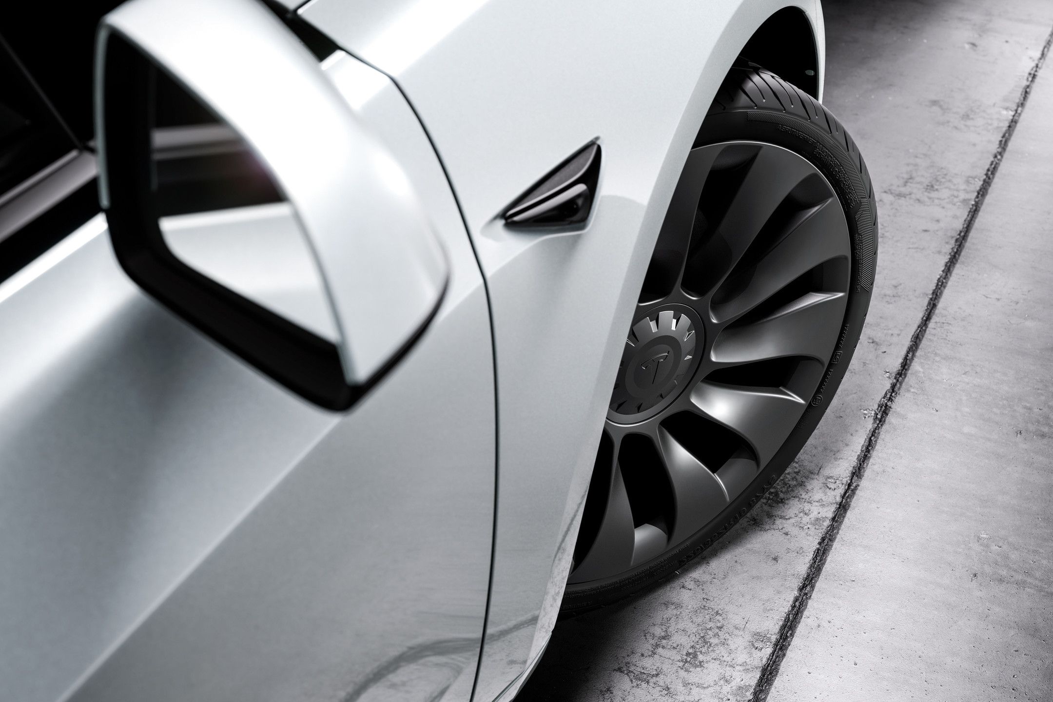 A closeup on the wheels of the Tesla Model 3.