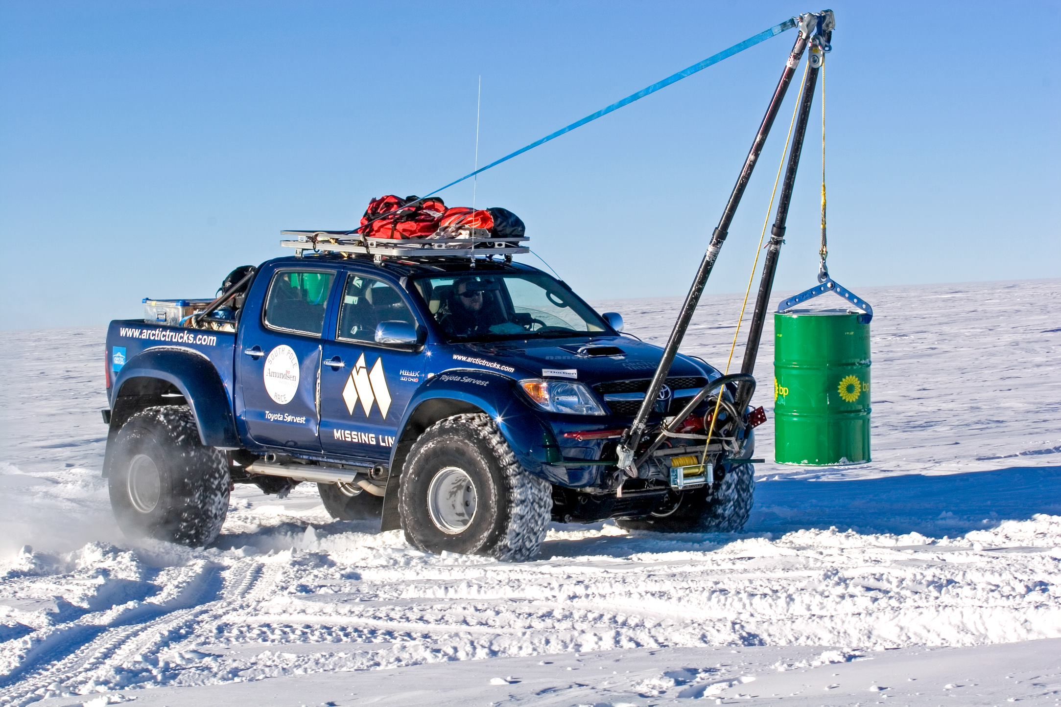 Blue Toyota Hilux by Arctic Trucks is being used for crane solutions.