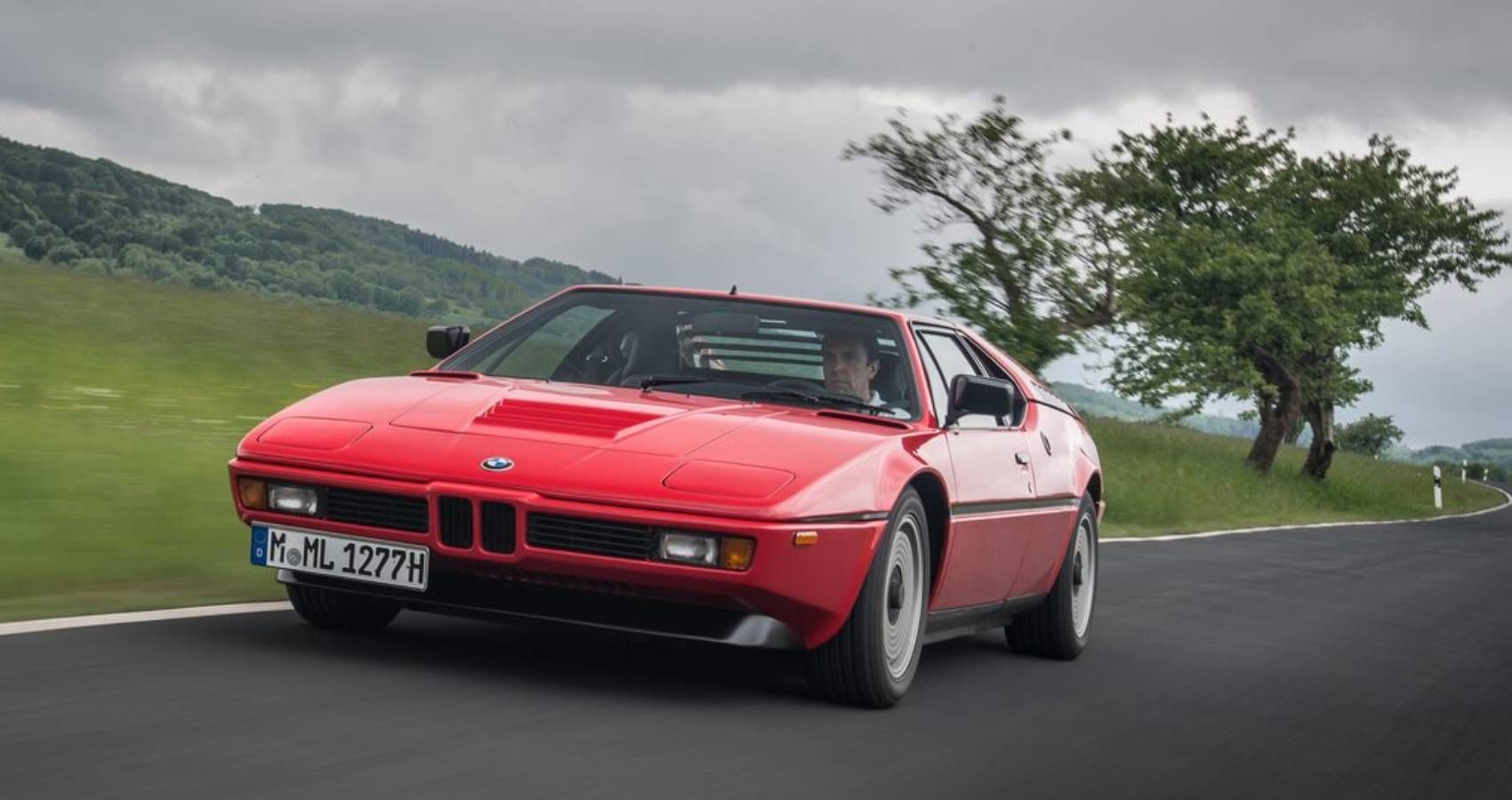 Red BMW M1 on the road
