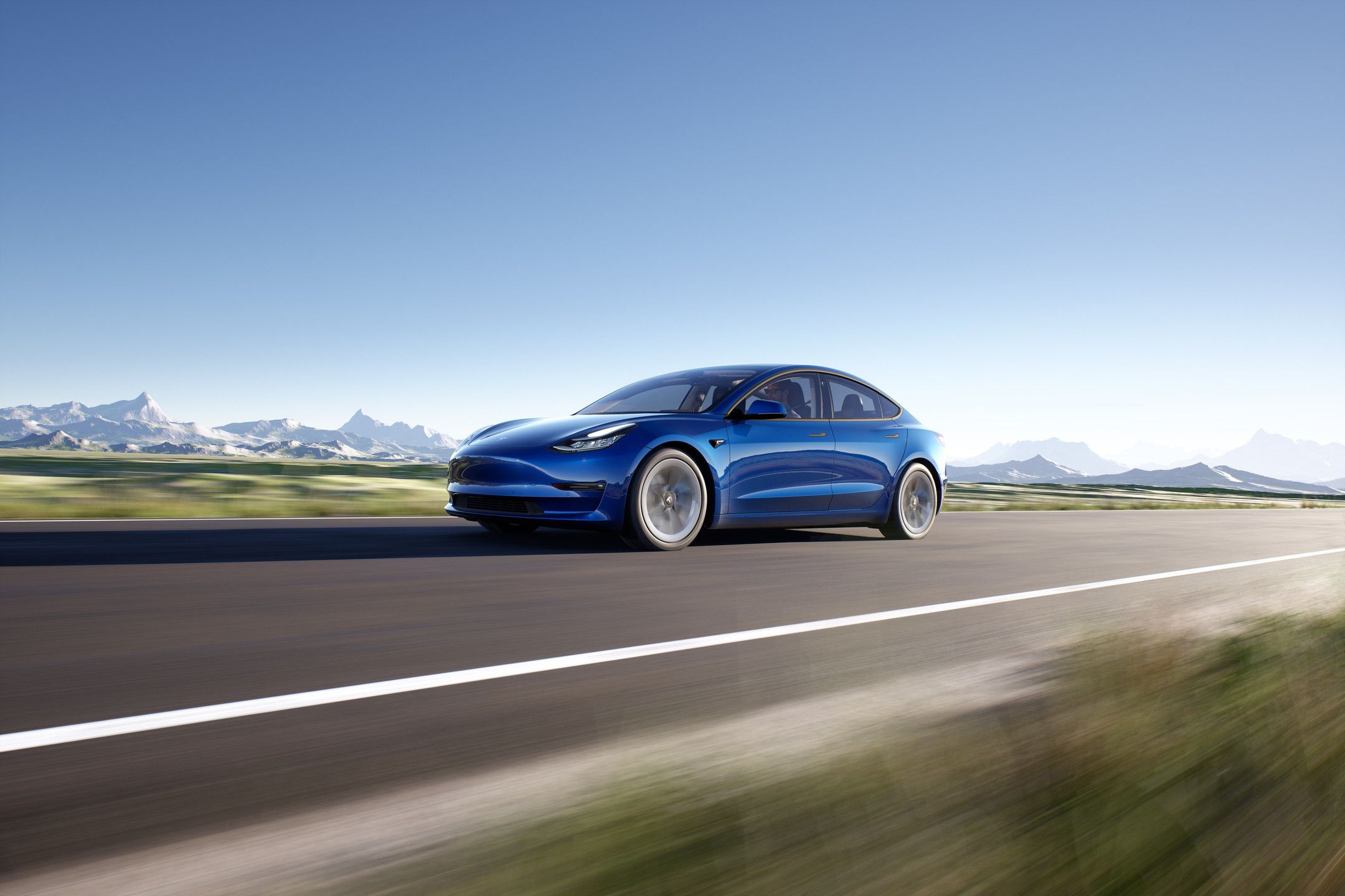 The blue Tesla Model 3 hits the road.