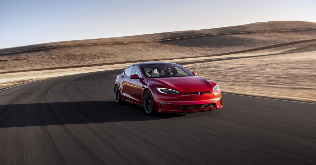 The Tesla Model S speeds up on the road. 