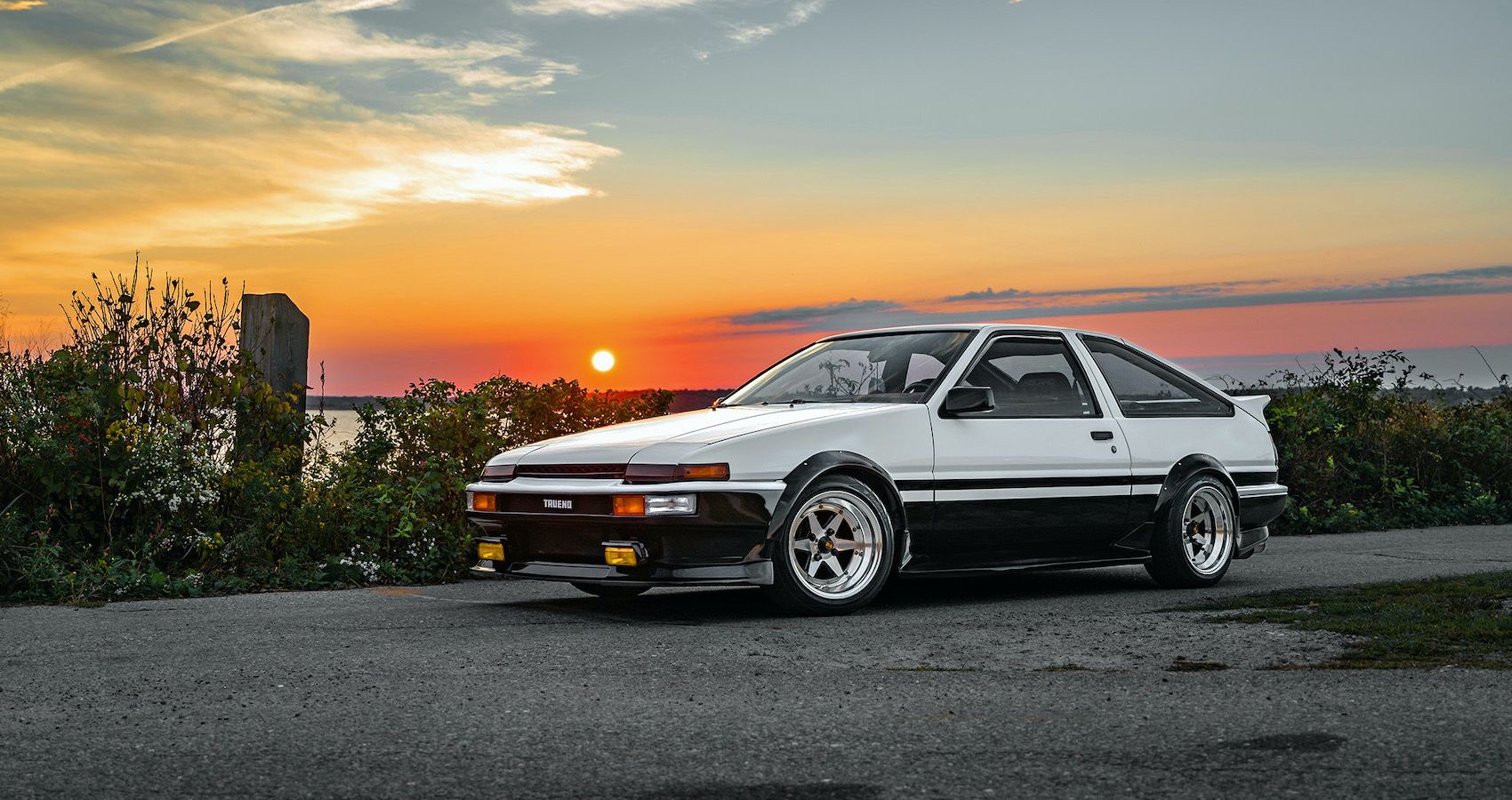 Toyota Corolla AE86 'Hachi-Roku' parked by the lake.