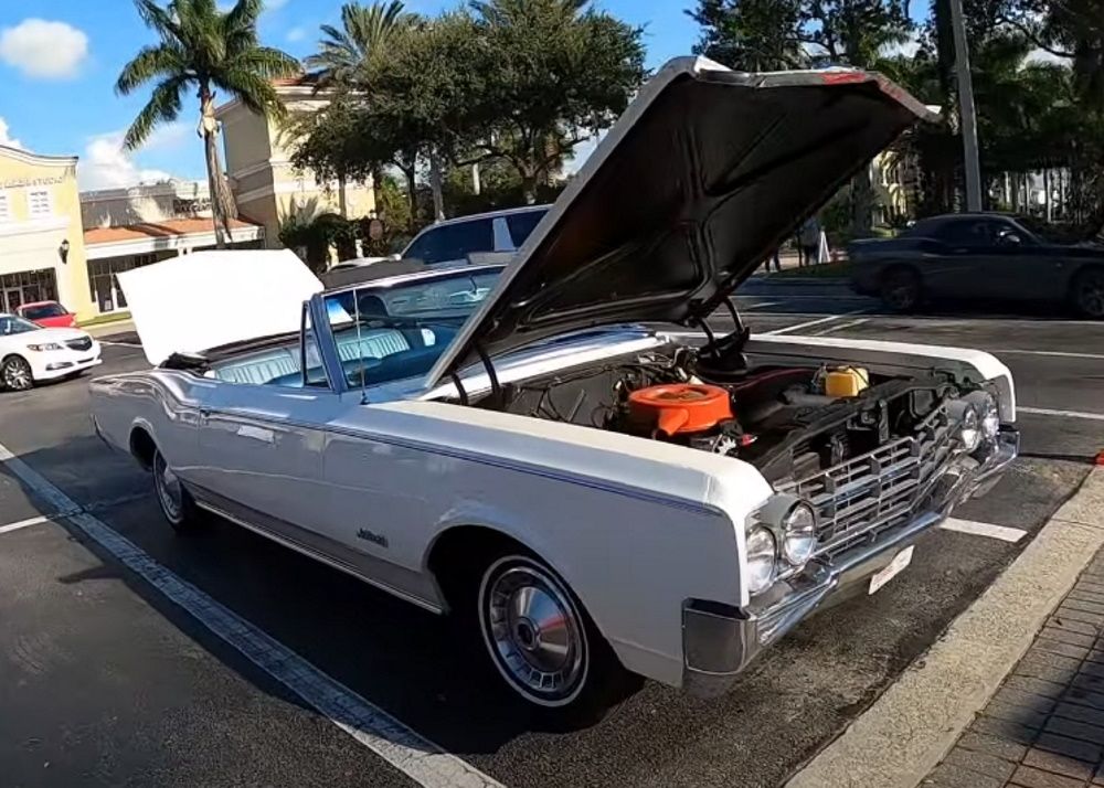 A white 1965 Oldsmobile Jetstar 88 Convertible with the hood and trunk open