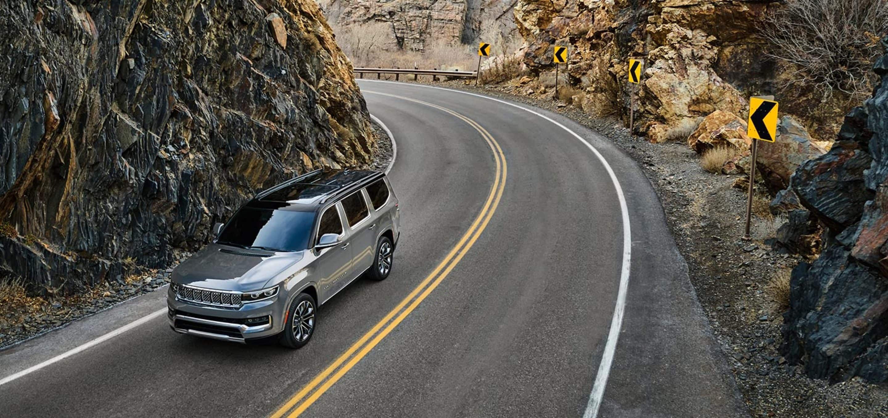 The 2022 Jeep Grand Wagoneer speeds up on the road. 