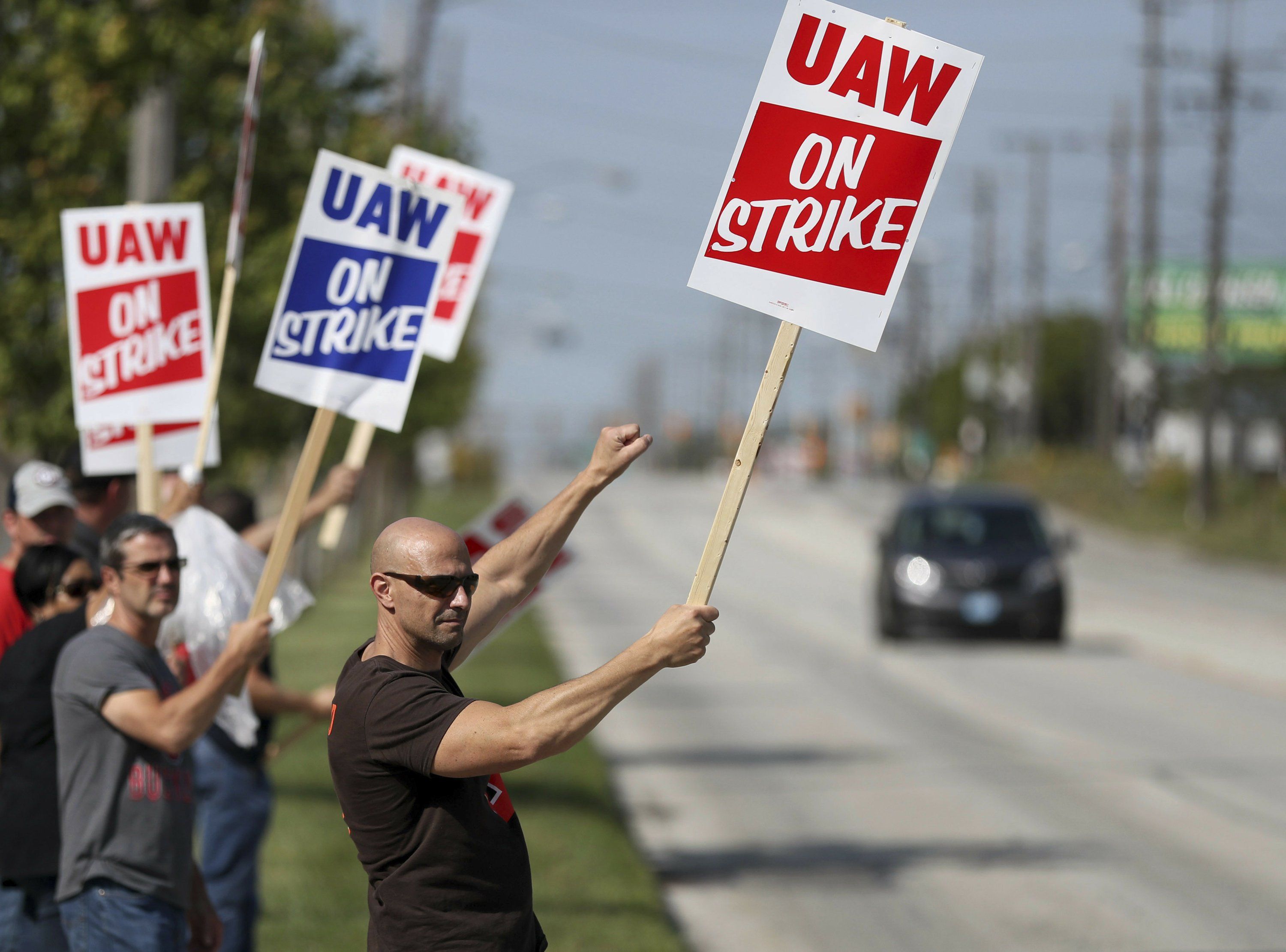 UAW unionists holding strike placards  