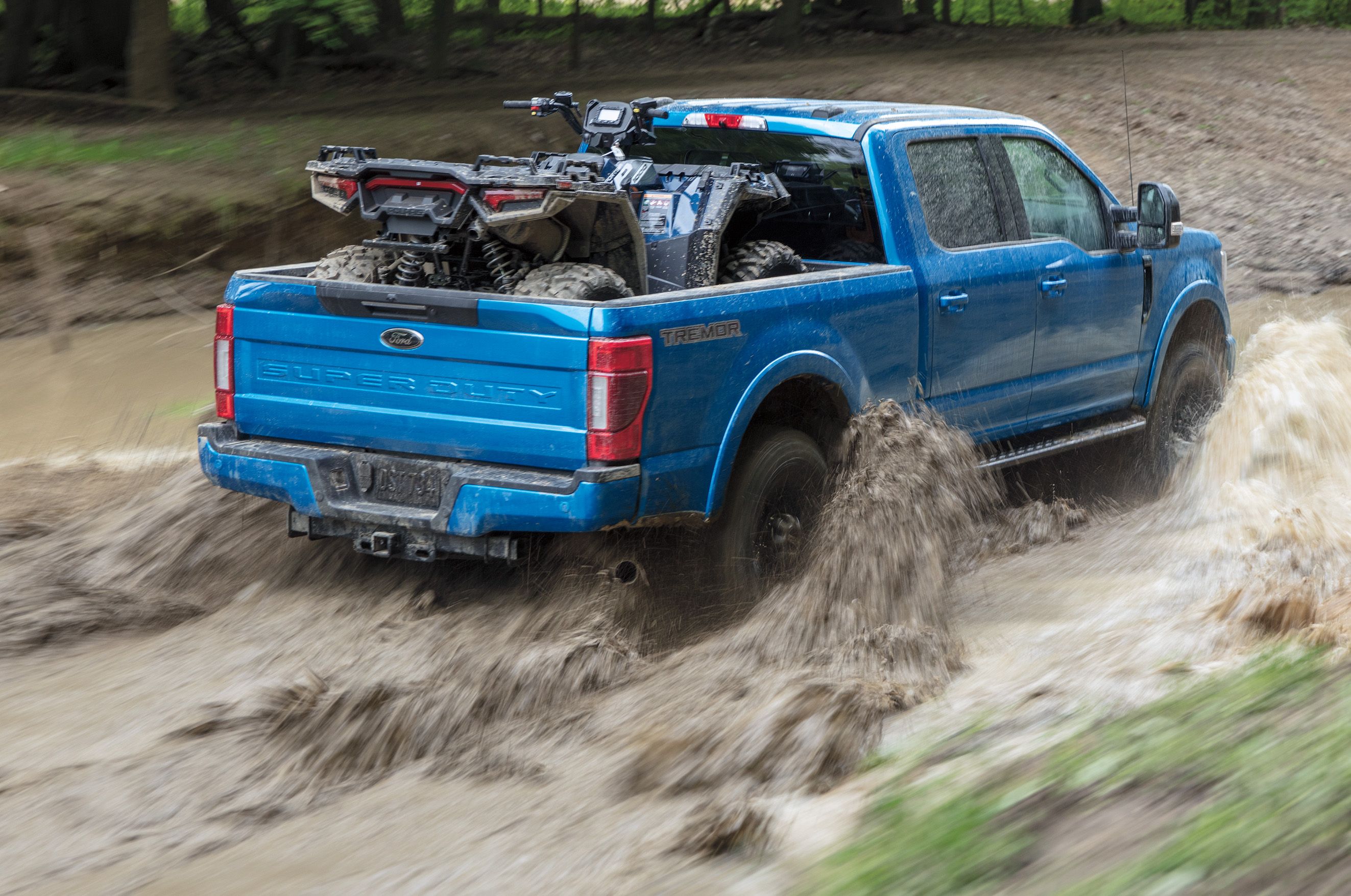 Ford Super Duty 2021 Rear View In Blue Splashing In Mud