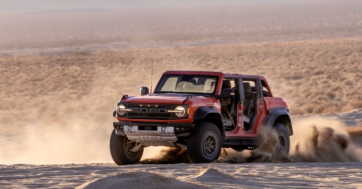The 2022 Ford Bronco Raptor drives in the desert.